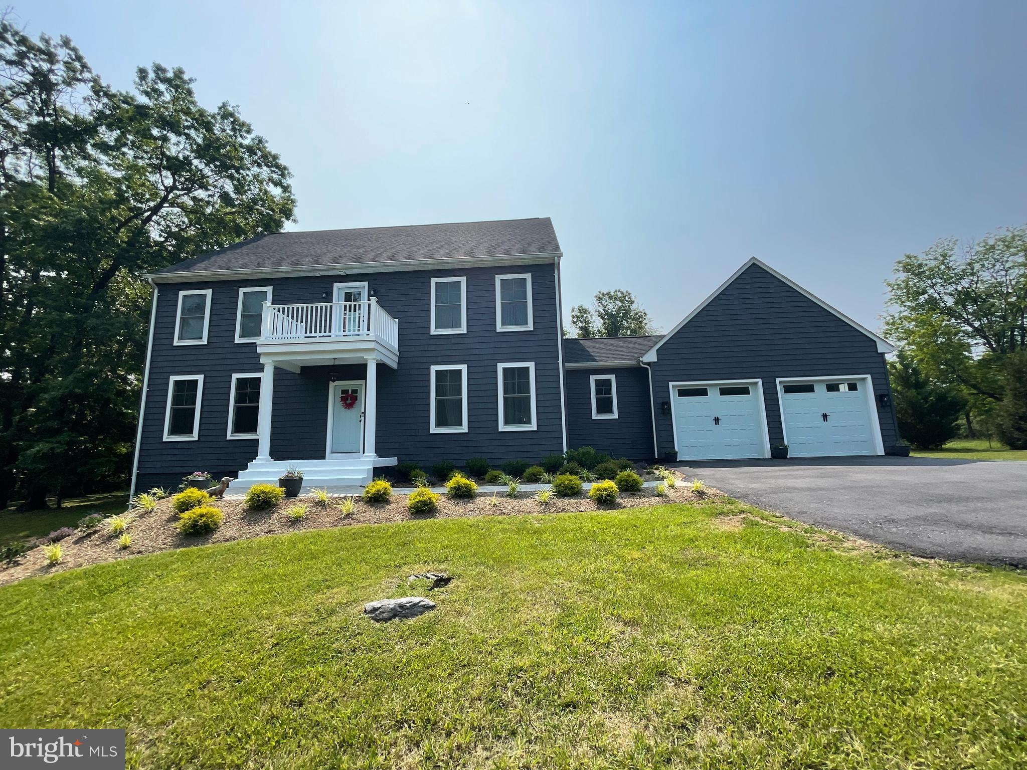 This exceptional home offers the perfect blend of privacy and convenience, nestled on a beautifully treed lot with serene views from every window—including breathtaking vistas of Skyline Drive from the two rear patios and the upper-level deck off the master bedroom. Despite its tranquil, sanctuary-like setting, the property is less than five minutes from Target, Walmart, Starbucks, and Lowe’s, and Restaurants. Designed for both comfortable living and effortless entertaining, the home features a spacious open-concept kitchen, family room, and dining area, complemented by two outdoor patios. Two refrigerators offer ample space for food storage—ideal for hosting gatherings or separating family groceries. With two laundry rooms (one on each level), a private office with high-speed Xfinity internet, and thoughtful upgrades such as gutter leaf guards, a paved asphalt driveway, front paver walkway with landscaping, and a tankless water heater, this home is as functional as it is inviting. More Info- Aerobic Septic system was pumped in August 2024, and has a maintenance agreement. Exterior lawn maintenance is paid for the remainder of this season. The last mow is usually in October – so the purchasers will not have the lawn to worry about this year, allowing them to spend time getting settled. The propane tank which is leased runs the gas fireplace, kitchen stove, and tankless water heater. Electric Dual Zone central A/C with 2 heat pumps. Water Treatment system is Culligan. Comcast is the internet and cable provider. The TV and mount above the mantle can convey. The HOA takes care of snow removal, and road maintenance, and is paid once a year. There are 4 Bedrooms and 2 Full baths upstairs, and 1 full bath on the first level, with room for an extra bedroom. This well maintained home is a must see!