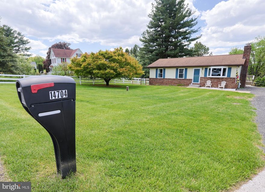 Welcome to 14704 Old Hanover Rd; where privacy, comfort, and everyday convenience come together seamlessly. Nestled on a peaceful and secluded .45-acre lot, this charming rancher offers the rare opportunity to enjoy a quiet, rural setting while remaining just minutes from major commuter routes like 795, making daily travel simple and efficient.

Step inside to a bright and inviting main level featuring hardwood floors, a spacious living room anchored by a cozy wood-burning fireplace, and a functional kitchen with butcher block countertops and stainless-steel appliances. The layout flows effortlessly, offering three well-sized bedrooms, including a primary suite with its own private half bath; designed for both comfort and convenience.

The unfinished walkout basement presents incredible potential. Whether you're envisioning additional living space, a home gym, workshop, or recreation area, the opportunity to add value and customize to your lifestyle is already here.

Outside, the property truly shines. Enjoy peaceful mornings and relaxing evenings on the deck overlooking your private, fenced backyard — perfect for entertaining, pets, or simply unwinding in your own scenic retreat. The expansive driveway provides ample parking, while the surrounding views of open lawn and countryside create a setting that feels miles away from it all.

If you’ve been searching for a home that offers space, privacy, and accessibility—without compromise—this is it.