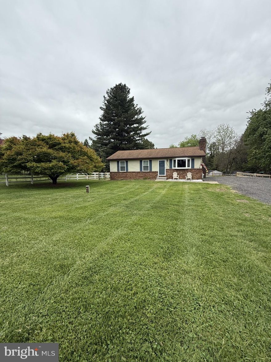 Welcome to 14704 Old Hanover Rd; where privacy, comfort, and everyday convenience come together seamlessly. Nestled on a peaceful and secluded .45-acre lot, this charming rancher offers the rare opportunity to enjoy a quiet, rural setting while remaining just minutes from major commuter routes like 795, making daily travel simple and efficient.

Step inside to a bright and inviting main level featuring hardwood floors, a spacious living room anchored by a cozy wood-burning fireplace, and a functional kitchen with butcher block countertops and stainless-steel appliances. The layout flows effortlessly, offering three well-sized bedrooms, including a primary suite with its own private half bath; designed for both comfort and convenience.

The unfinished walkout basement presents incredible potential. Whether you're envisioning additional living space, a home gym, workshop, or recreation area, the opportunity to add value and customize to your lifestyle is already here.

Outside, the property truly shines. Enjoy peaceful mornings and relaxing evenings on the deck overlooking your private, fenced backyard — perfect for entertaining, pets, or simply unwinding in your own scenic retreat. The expansive driveway provides ample parking, while the surrounding views of open lawn and countryside create a setting that feels miles away from it all.

If you’ve been searching for a home that offers space, privacy, and accessibility—without compromise—this is it.