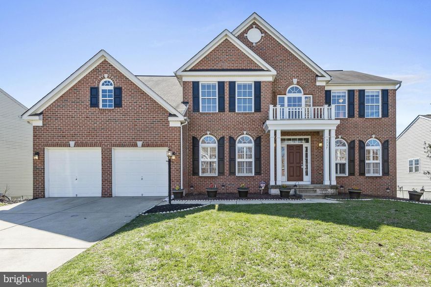 Absolutely stunning brick front colonial w/ two story foyer, gleaming hrdwd flrs, plantation shutters &decorative molding& columns. Gourmet KIT w/ center Island, SS appls& brkfst bar, 1st flr laundry and den. Spacious master bedroom w/ walk in cls& lux bath. LL w/ 1556 finished sqft featuring 5th bedroom, full bath, rec rm, surround sound, custom wet bar& walkout access. Expansive deck& irrigation