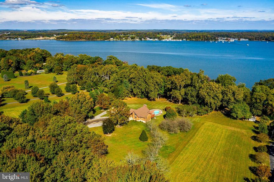 In Battery Park is this outstanding 5 acre waterfront property providing the best of the Eastern Shore.  Located on a well landscaped and private lot, this beautiful 5 bedroom, 3.5 bath home boasts water-views from every room.  Features include a large open living room-dining room with vaulted ceilings, cozy fireplace and large light-filled windows: a gourmet kitchen with breakfast room; a beautiful primary bedroom with large private deck; two private office spaces; an over-sized 2 car garage; additional garage space on the lower level, an in-ground swimming pool; and a private dock with water/power hook-up. The property has room for horses, gardens and more. This is truly an amazing property and a rare offering in sought after Battery Point Farms!