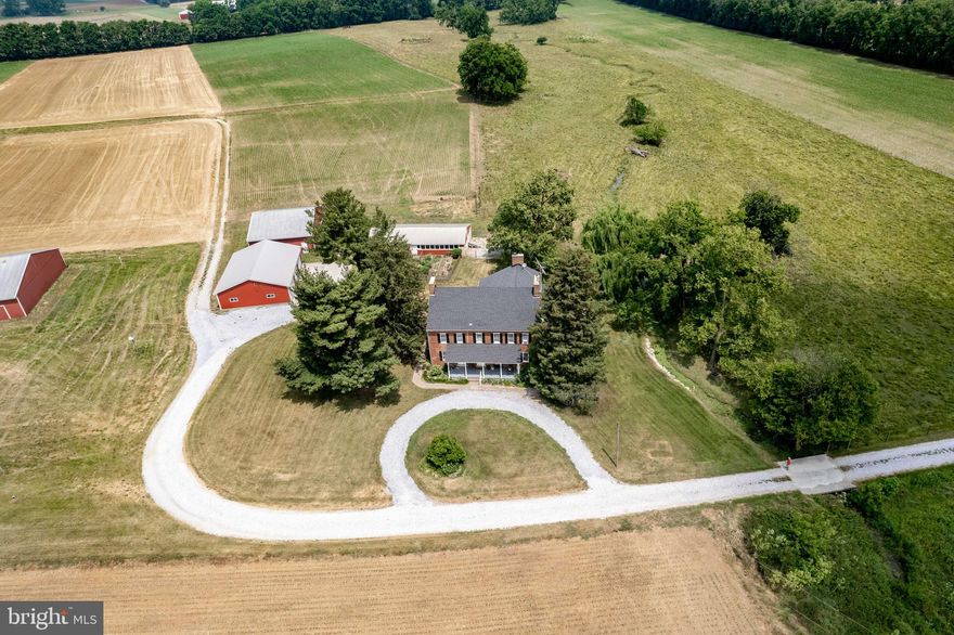 *Dream Farmette on a truly peaceful setting*Welcome to 1100 Winters Church Rd*This Farmette features a beautifully renovated large 4,000+ sq ft 5BR 2.5 Bath 18th Century historical home (new roof 2017), a large newer barn, a smaller barn, a multi-purpose chicken house/kennel, & a newer 6 car detached garage (2011)*Both barns built in 1989 are in very good condition*Detached garage is ideal for your vehicles, farm equipment, or hobbies*Amazing views surrounded by lush farmland, distant mountains, pastures, & stream*Inside home main level features wide plank wood floors, custom moldings, exposed beam ceilings, exposed brick, multiple fireplaces, renovated bathrooms, large country kitchen with island, built ins, a light filled sun room, a large mud/laundry room, an office, & a half bath*Upper level has 5 large bedrooms, 2 full baths, a rustic bonus room, & additional stairways*Multiple walk up floored attic access for additional storage*Lower level has a utility room, 2 storage rooms, & a bonus walk out room that could be another bedroom*Currently selling 6 acres with an additional 16 acre pasture for a total of 22 acres*

History of 1100 Winters Church Rd Farm:
The farmhouse was built in 1806 with bricks that were made on the property. It is situated on 136 acres of beautiful farmland in a secluded valley of rolling hills, woods, and two clear streams and surrounded by fertile productive working farms. The builder was one of seven farmers who formed the nation’s first farmers marketing organization, selling in Baltimore. This was a predecessor of the National Grange and Farm Bureau Federation. It is also believed to have been part of the Underground Railroad. As you enter the main hall, the original four rooms are the dining room and formal parlor on the right and the two bedrooms above them. The rooms to the left below and above were built a bit later, thus the two front doors. The original brick end barn, built in 1811, burned down in 1987.  The original kitchen was outside, and some stones from the foundation can still be seen. The property was originally part of Frederick County, so research of the deeds is challenging.

The house is very unique with 18th century architecture, hand-crafted woodwork, hardware, most floors are original chestnut, four rooms re-floored with fine oak, nine foot ceilings, fourteen inch thick brick walls, stone foundation, eight original fireplaces, original glass in most of 9 over 6 windows, beautiful center hall, three attics and staircases, two enclosed heated porches, a fully heated, air-conditioned sun room overlooking the patio, stream, both farm and wild animals, and a full variety of wild birds. The house is fully restored with care to preserve historical features. Beautiful crystal chandeliers grace the formal parlor, dining room and great hall. The kitchen was completely restored in 1985, opening up the fireplace, exposing the half- sawn oak floors, and Master Cabinet Maker, William Duble installing hand crafted oak cabinets, butcher block counters and pantry to match the original one that has a dumb waiter.

Other things to consider:
The many beautiful views from the sunroom, sunset from the upstairs sun porch, deer in the rolling hills from the front porch swing, walking or riding horseback on the farm, growing vegetables, herbs, flowers, or exploring the woods and streams.