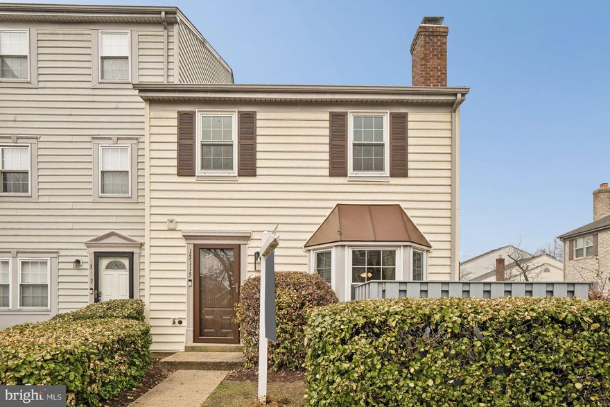 Two-level end unit townhome-style condominium offering 1,280 square feet of interior space. The main level includes hardwood flooring, a living room with a bay window and brick fireplace, separate dining area, and an eat-in kitchen with sliding glass door access to the patio. Upstairs features a primary bedroom with an en-suite bathroom and walk-in closet, two additional bedrooms, and a full hall bathroom. Community amenities include a pool, basketball and tennis courts. Conveniently located with direct access to commuter routes and proximity to shopping and services in Silver Spring.