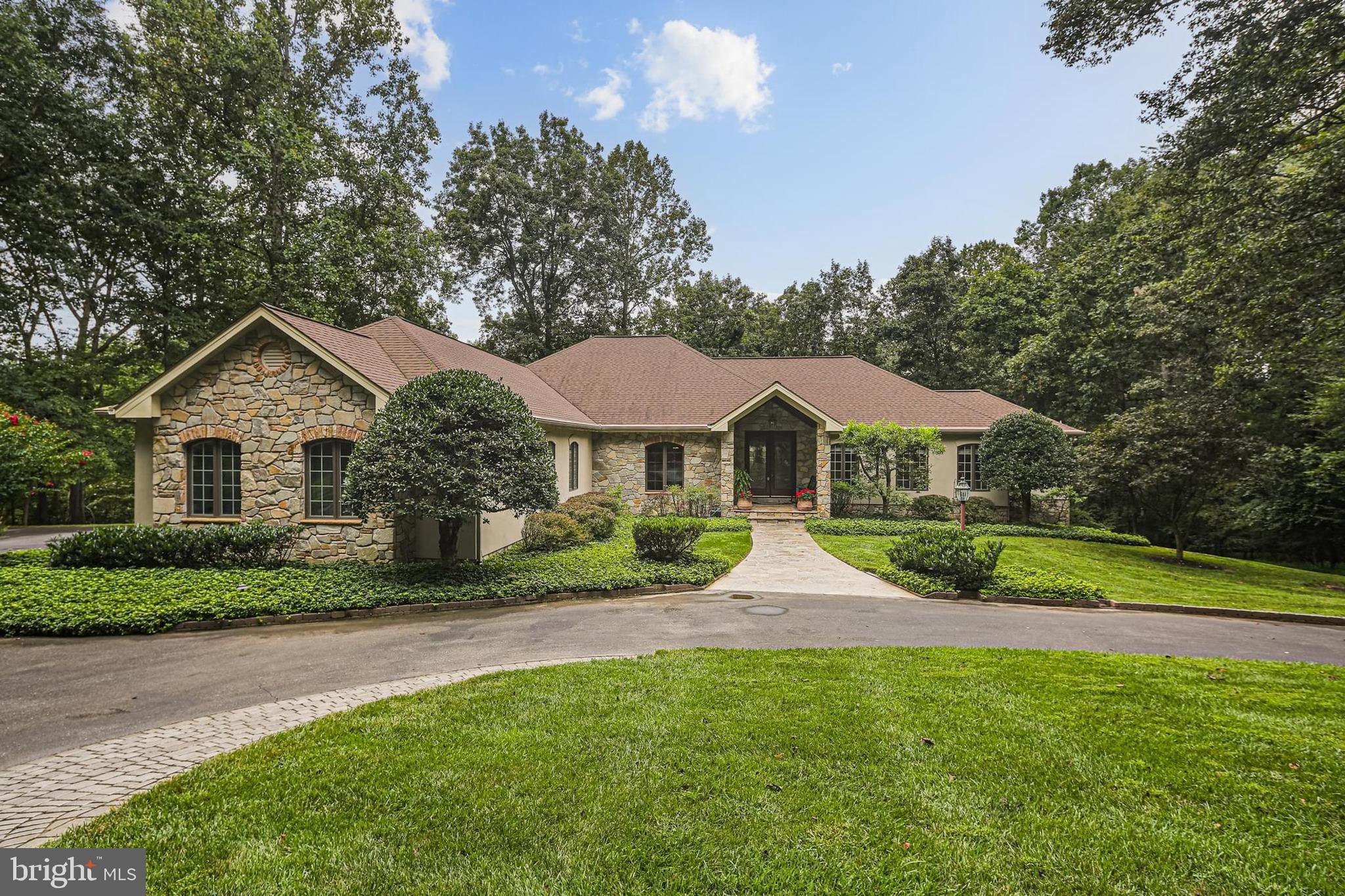Welcome to 3651 Broadleaf Ct - an extraordinary estate in the exclusive Cattail Creek Country Club community. Perfectly positioned on a private 3.35-acre cul-de-sac lot, this residence offers over 7,700 total square feet of refined living space, blending sophistication with comfort in one of the region’s most sought-after settings. A stone front porch and grand foyer welcome family and friends as you enter this magnificent home. Entertain with ease in the expansive dining room featuring a custom built-in bar, or gather in the warm family room accented by a dramatic stone fireplace. The gourmet kitchen is a chef’s dream, boasting vaulted ceilings with skylight, granite countertops, large island, high-end appliances including a double oven, Sub-Zero refrigerator, gas cooktop, and generous pantry. A sunny breakfast area, tray-ceiling living room, private office with fireplace and built-ins, and a large laundry room complete the main level. The luxurious primary suite offers a vaulted ceiling, dual walk-in closets, dressing area, and spa-like bath with jacuzzi tub, walk-in shower, and dual vanities. Two additional bedrooms share a full bath with dual vanity. The finished lower level is designed for entertaining and multi-generational living with a spacious rec room with built-in entertainment center, a full commercial grade bar with sink, refrigerator, and wine unit, a guest bedroom, full bath with steam shower and dual vanity, and bonus room. Ample storage ensures everything has its place. Outdoor living is unmatched with a Trex deck and an extensive stone patio featuring an in-ground spa and fire pit, all overlooking the fifth hole of Cattail Creek—affectionately known as “the rock hole” or “the cliff hole.” Thoughtful exterior lighting and professional landscaping add to the ambiance. Additional highlights include a circular driveway, 3-car garage, and whole-house generator. This remarkable home offers elegance, privacy, and the ultimate country club lifestyle in a premier location. Schedule your tour today!