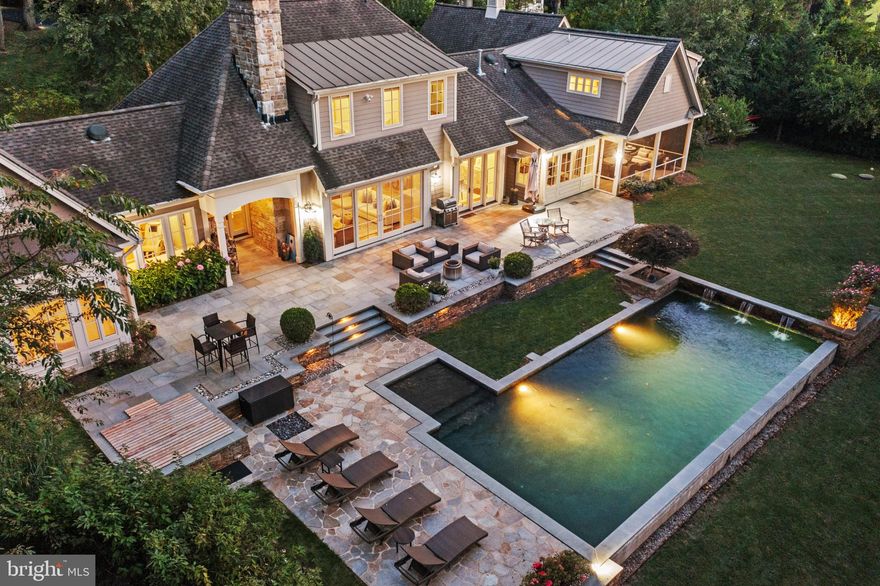 EXQUISITE HOME - GREAT NEW PRICE! 

Discover an exquisite piece of architectural artistry nestled on a private 1.55-acre lot in the heart of Owings Mills thoughtfully designed by the late, revered Baltimore architect Donald Ratcliffe and meticulously crafted by the esteemed luxury custom home builder, Raphael Homes. This exceptional residence exudes the timeless charm of French Country architecture harmonizing seamlessly with the luxuriant, beautifully landscaped partially wooded grounds. From the arched walkways and windows to the natural stone facade and front entry stone portico with detailed trim paneling, the impressive craftsmanship, fine materials and extensive millwork define every corner of the home's luxurious yet effortless stylings. With over $100,000 in recent updates and renovations, this stunning 5-bedroom, 6-bathroom, 2-half bath masterpiece is the true embodiment of luxury living.

As you step inside the home, you are greeted by the radiant foyer and seamless view of the lush backyard. The abundant natural light accentuates the main level's open-concept, living room, dining room, and chef's kitchen creating a warm and inviting atmosphere ideal for everyday living and entertaining. The recently added SONOS indoor & outdoor sound system enhances the ambiance of the home ensuring an immersive auditory experience. A culinary dream, the recently upgraded gourmet kitchen features top-of-the-line appliances from Subzero, dual Cove dishwashers, a Wolf gas cooktop, wine fridge, and oversized center island with custom-fit microwave drawer and Scotsman ice machine. The dining and living rooms floor to ceiling windows and doors effortlessly transition outdoors to the newly expanded flagstone patio overlooking the upgraded heated saltwater pool, invigorating spa, Japanese red maple and the magnificent, unobstructed views of Caves Farm's 100s of protected acres of horse farm.

The expansive main level owner's wing delivers the ultimate private sanctuary featuring a luminous home office adorned with tasteful custom built-ins, the sun-soaked primary bedroom with elegant French doors that open directly to the captivating backyard, dual walk-in closets providing ample wardrobe space, generously sized dressing room and spacious luxury ensuite bath for that spa-like retreat. A main entry powder room, additional sitting room/library with french doors that step out to a spacious screened porch, a laundry room with built-ins, and large mudroom with its own powder room complete the Main Level.

The upper level offers four additional spacious guest suites, each with its own ensuite bath and walk-in closets, providing a haven of comfort and privacy. The entertainer's paradise continues in the fully finished lower level with stair access out to the pool, spa and backyard, a full second kitchen with dining area and breakfast bar, a billiards area, living room, full bath, rec room AND TWO additional bonus rooms offering endless possibilities - a gym, gaming or crafts rooms; perhaps your own personal yoga or meditation sanctuary, or even a private wine tasting room. Whatever you decide, you will not be disappointed! Boasting an expansive circular wrap-around driveway, this property offers ample open-air parking spaces. In addition, an oversized 2-car garage, conveniently situated off the side of the home, is equipped with EV charger and additional storage.

With Caves Farm at your backdoor catering to top-tier equestrians and a short distance from the esteemed Green Spring Hunt Club and Caves Valley Golf Club, you are situated in a perfect setting for relaxation and sophistication. The home is set amongst some of the most prestigious private schools including Garrison Forest, McDonough, St. Paul's and The Park School. 28 Caveswood Lane embodies unparalleled elegance and sophistication. Its unique blend of style, comfort and functionality is not to be missed. Embrace the epitome of luxury living and make this dream home a reality.