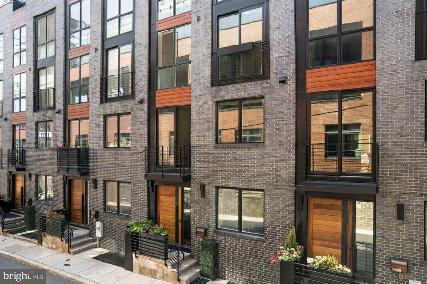 1328 Kater Street is an exceptional, expansive luxury townhome — a rare opportunity to own a home of this scale, design, and finish, with 3 years remaining on the tax abatement. Beautifully decorated and impeccably presented, the home delivers an immediate wow factor from the moment you step inside. Generous proportions, soaring ceilings, and wide plank wood floors create an open, airy feel throughout, while thoughtful architectural design and curated finishes give every space a polished, elevated look. An in-home elevator provides seamless access to every level, adding both convenience and long-term livability.

The home offers 4 bedrooms, 3 full baths, and 3 half baths, with incredible flexibility across every level. The chef’s kitchen is a true standout, featuring Wolf and Sub-Zero appliances, handcrafted cabinetry, a stunning backsplash, and statement lighting that anchors the space. An elegant fireplace warms the main living area, while electric blinds from Allure are installed throughout, adding both convenience and a clean, modern finish. The home is also equipped with a Russound whole-home audio system, with built-in speakers throughout — including the primary bedroom and bath — creating a seamless, elevated sound experience across multiple levels.

Outdoor living is just as impressive. Multiple outdoor spaces include beautifully planted decks, a charming terrace off the main living area with a grill, and a spectacular upper deck with a retractable pergola — all coming together to create a private, resort-like setting ideal for both relaxing and entertaining.

A flexible entry-level living space with a half bath and large window overlooking the serene street is ideal for a home office, lounge, or additional living area. The primary suite is a true retreat, complete with two custom walk-in closets, incredible natural light, and a spa-like bath featuring a soaking tub, oversized glass shower, and Waterworks fixtures. Two additional large bedrooms offer generous space and flexibility, while closet space throughout the home is extensive and thoughtfully built out.

The top floor adds even more versatility with a bonus den, wet bar, and fireplace — an ideal space for entertaining or unwinding. A massive finished basement offers incredible additional living space, easily accommodating a home gym, playroom, or even a fourth bedroom. The rear portion has been thoughtfully prepared as an entertainment or theater-style media room with built in speakers and an audio system. With a full bathroom featuring a walk-in shower and ample storage throughout, the space also functions seamlessly as a guest suite, private retreat, or flexible living area.

A two-car garage and gated parking within a central courtyard complete the home with unmatched convenience. Set on a peaceful, tree-lined street in a private enclave that feels tucked away yet is just steps from neighborhood favorites, this home offers the best of both worlds — quiet, refined living with easy access to everything. Homes of this size, finish, and quality rarely become available — a truly special opportunity.