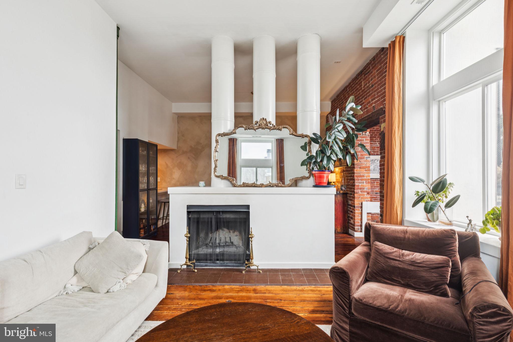 Welcome to 765 S 2nd Street #G! This light-filled 2-bedroom, 1-bathroom top-floor unit is nestled in the heart of Queen Village, between Fitzwater and Catharine Street. This warm and inviting home boasts original hardwood floors, soaring ceilings, and oversized windows that flood the space with natural light. As you enter, you'll notice exposed brick and timeless architectural charm as you make your way to the spacious living area. The living area features a wood-burning fireplace while the kitchen boasts a stainless steel refrigerator and wooden cabinetry for storage. The recently renovated full bathroom offers black fixtures and floor to ceiling tiled shower. Storage won’t be an issue with access to a private attic space and additional designated storage in the shared basement. The beautifully maintained shared courtyard features a grill and pergola seating — perfect for relaxing or entertaining. Located just minutes from I-95 and only a few blocks from vibrant South Street, you’re steps from local favorites like Bridget Foy’s, Paddy Whacks Irish Sports Pub, cozy coffee shops, and boutique shopping. Schedule your showing today!