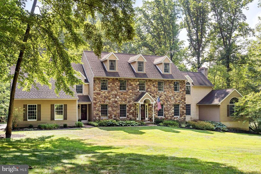 Welcome to Soleberry Acres, a gracious stone front home on over three private acres along scenic Greenhill Road in New Hope. Great for entertaining, the well-appointed cook’s kitchen blends seamlessly with a spacious family room and it’s stone fireplace. The kitchen offers custom cabinetry, 48”  Viking stove, hood and refrigerator, convection microwave, warming drawer, granite counters, and plenty of room for dining. Both Kitchen and Family room have French doors leading to a wonderful deck overlooking the private yard, gardens, and woodlands.  Other rooms include Living Room/Bar, Dining Room, and a large private office with custom cabinetry and vaulted ceilings.
The Upstairs offers five bedrooms; one of the bedrooms is perfect for a 2nd main bedroom, in-law or nanny suite.  The Owners suite includes cathedral ceilings, sunny morning views, ample walk-in closet, and gas fireplace.  The Main Bath has  a seamless glass shower, soaking tub and separate commode. Walk up to the full-height third level, which is great for storage or could be easily finished for additional space.
Downstairs enjoy a wonderful home theatre, gym, an exquisite 1000-bottle brick wine cellar constructed of antique brick and poplar trees from the property, and roomy storage/workshop. Walk out to a lower level patio. The oversized 3-car garage is a delight for the car enthusiast. Amenities include natural gas, oak floors throughout, Generac generator, Grohe filtered and carbonated water,  ; see full list of amenities.
The property is located in the award-winning New Hope-Solebury school district.  5 minutes to downtown New Hope shopping and restaurants, 2 minutes to Peddlers Village, 15 minutes to Doylestown Borough.