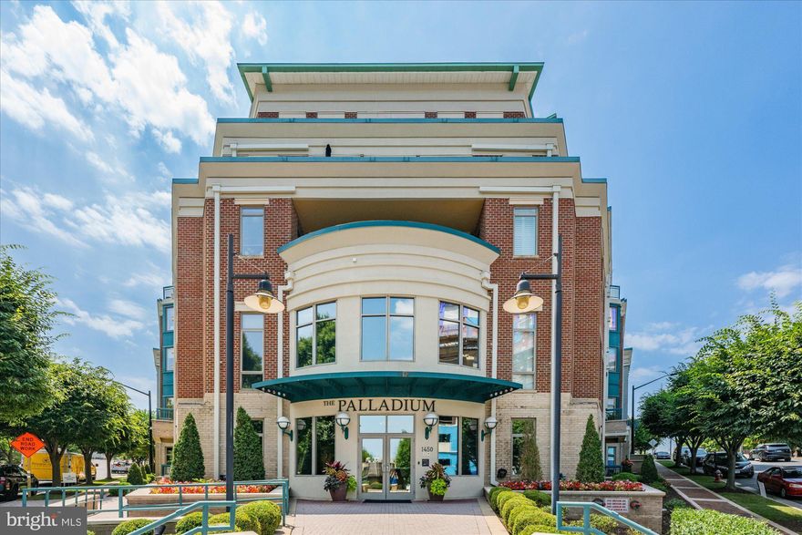 You cannot help but smile as you step into this stunning light-filled penthouse, featuring ten-foot ceilings, intricate crown molding, hardwood floors, new carpet, a wall of windows and plenty of wall space for artwork. Located in the luxurious Palladium, this is a one-of-a-kind offering. With a unique floor plan, this unit is perfect for large-scale entertaining or delighting in just living in this gorgeous condo by relaxing in the numerous reading or working spaces, cooking in the beautifully-appointed kitchen, and enjoying the awesome views of the sky, the stars and the elegant McLean community.  A large foyer greets guests and features a convenient coat closet and powder room. The foyer leads to the gallery, flanked on one side by the living room and the other by the extraordinarily spacious dining room perfect for large dinner parties. Multiple rooms lead to the expansive terrace, which is approximately 110-feet long, and has lovely space for an outdoor eating area and outdoor entertaining with beautiful northeastern views. The updated and exceptional custom eat-in kitchen is a chef’s dream with new quartz countertops, KitchenAid appliances, a fourteen-foot-long countertop, built-in bookshelves plus a separate butler’s pantry with additional storage and prep space. The primary bedroom is spacious and provides a sitting room/office and two sizable walk-in closets. The primary bath offers dual vanities, a soaking tub, separate shower and a private water closet. On the opposite side of the condo, there is a second bedroom suite with a walk-in closet and an updated bathroom. The library/den has three walls of built-in bookcases, offering plenty of room for your books and photos.  A walk-in laundry room completes this condo. Two assigned underground parking spaces and two large storage rooms convey. The Palladium amenities include a staffed front desk, a gym, a party room and outdoor spaces including a courtyard and a large plaza with a fountain. To the best of our knowledge, this is one of the largest condos in sought after McLean and offering the largest terrace in McLean. You do not need to get rid of many of your personal treasures when you move in here as this unit offers so many closets and storage spaces, including two very large walk-in closets in the primary bedroom. In addition, there are two over-sized storage units with built-in shelves located in the secured garage. Truly one-of-a-kind, this offering provides all of the entertaining space, storage and flexibility of a house with the ease, amenities and convenience of a condo. Walkable to all of the shops, restaurants and grocery stores McLean has to offer, this central location is also ideal for easy commuting to Tysons, Reston, Arlington and Washington, DC with its close proximity to many commuter routes.