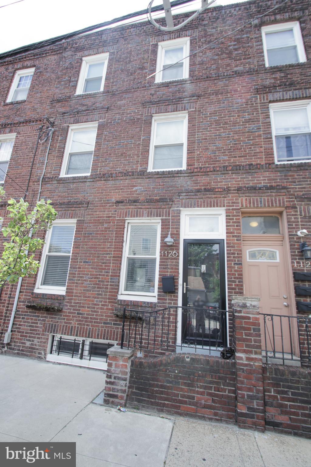 Wow, what a location! Just south of Graduate Hospital and located near just about everything! Grab all of your home essentials and grocery needs with a short walk to the brand new Target and Sprouts stores. Or, for some entertainment and more shopping options, you're just a block from Broad St and a short trip away from Center City, Passyunk Square, the Italian Market..and the list goes on and on. Less than 2 blocks from the Ellsworth-Federal subway stop makes for easy trips down to the sports complex, FDR park, or across town to go exploring and visit friends. This beautiful home features 2200+ sq. ft of living space, 3 bedrooms, 2 and a half baths, a finished basement, a huge fenced-in yard AND a roof deck with amazing unobstructed views of the city! Enter into a wide open living/dining space with high ceilings, coat closet and powder room. You'll quickly notice the bamboo flooring featured throughout the home. The contemporary kitchen features a quartz countertop, handsome cabinetry, stainless appliances, sleek backsplash, bar counter and French door to your own breakfast nook. The second floor features 2 bedrooms, a modern bath, and a conveniently located laundry room. The third floor Master Suite features a spacious bedroom with walk-in closet and a master bath with a rainfall shower. The finished basement would make a great playroom, office or den.