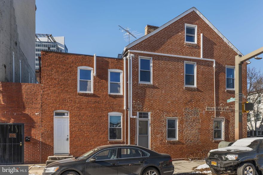 Discover the perfect blend of urban living and investment potential in this exceptional end-of-row townhouse, situated in the heart of Baltimore's historic Jonestown district. Zoned for mixed use, this property is thoughtfully divided into two distinct units.  The lower-level commercial space boasts incredible urban-industrial charm with exposed brick, an intricate wooden feature wall, high ceilings, and an open layout ideal for a boutique, studio, office, or creative endeavor. The character of this space is sure to inspire.
Upstairs, the loft-style apartment is a 2-bedroom, 1-bath retreat with a chic vibe. Featuring exposed brick walls, beams, and a light-filled layout, it includes a kitchenette perfect for meal prep, a cozy dining area, and a spacious living room for relaxation or entertaining. The shared laundry room, conveniently located on the entry level, adds to the practicality of the property.  Located across the street from vibrant Little Italy and just steps from Baltimore’s iconic Inner Harbor, this property offers unparalleled access to the city’s best dining, shopping, and entertainment. Whether you’re looking for an investment opportunity, a live-work setup, or a combination of both, this unique home delivers.  Don’t miss out on this incredible opportunity—schedule your showing today!