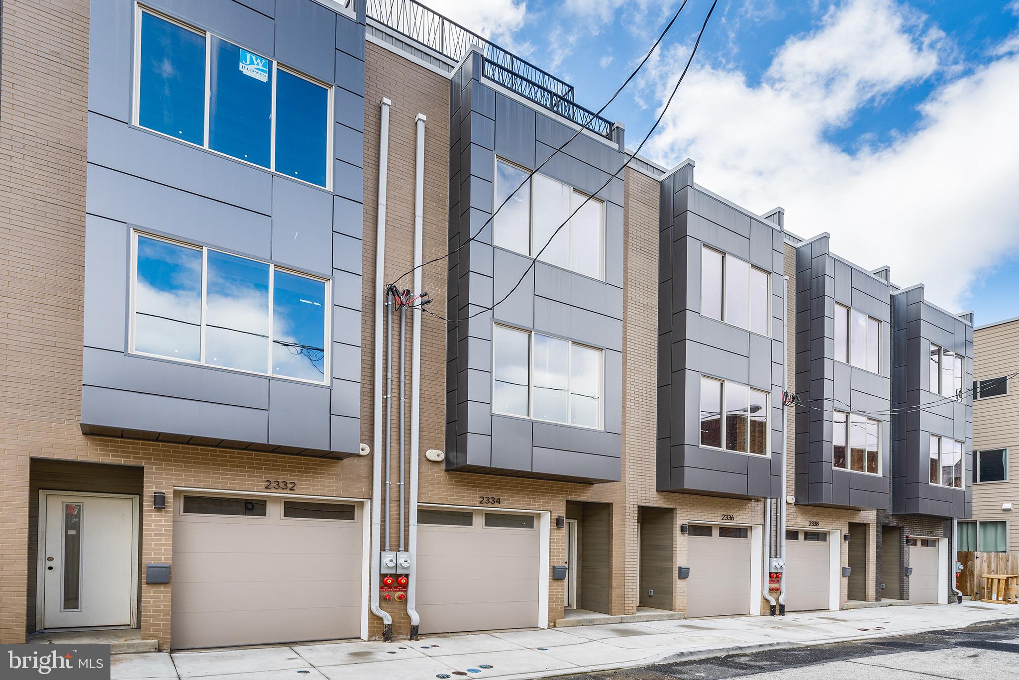 Introducing 2340 Alter Street, the customizable new construction home with garage parking that you’ve been waiting for. This end unit property is the largest of the Alter Street project and offers 2,975 square feet of living space including five bedrooms, four bathrooms with an abundance of versatility in its layout. It’s the opportunity to create a luxury home of your real estate dreams. Here, Buyers have the option to select kitchen cabinetry, countertops, backsplash, kitchen appliances, hardwood flooring, bathroom vanities and more. The layout of this home maximizes the use of the square footage and begins with a recessed entryway on the first floor complete with a coat closet. On this first level there is a full bathroom with seamless glass-door walk-in shower, a spacious bedroom with a row of closets and access to ground floor patio space. This bedroom offers great flexibility of use as it could easily function as a home office or in-law suite. Upstairs, you’ll find an open concept kitchen, dining and living area absolutely flooded with natural light from the oversized front window. The kitchen is a smart design with ample cabinet space, including a seamlessly built-in oversized pantry cabinet. The kitchen features a large island with waterfall quartz countertop that not only provides a stunning design accent but also offers plenty of space for meal preparation and countertop dining. The kitchen has a stainless steel appliance package including a gas stove with hood, counter-depth refrigerator, dishwasher, built-in microwave and wine fridge. There is a sliding glass door off of the kitchen that provides access to a rear balcony that is perfect for summertime grilling and easy outdoor dining. The living area itself easily fits large-scale furniture and is prewired for a wall mounted television. Hardwood floors of your selection will flow throughout all levels of this home. A floating staircase takes you to the third level of this home which features two good-sized guest bedrooms with ample closet space and a full bathroom. A proper laundry room complete with laundry sink is smartly tucked between the guest bedrooms. The fourth level is devoted to the primary suite which is an urban oasis, with an oversized spa-like bathroom complete with a freestanding soaking tub, massive walk-in shower and a generous walk-in closet that can be fully customized to fit all of your wardrobe needs. A unique feature of the primary suite is the private deck off of the bedroom that provides a secluded spot to retreat for some outdoor relaxation. The top level of this home was made for entertainment with a Northern facing roof deck that provides unobstructed panoramic views of the Philly skyline and is the perfect space to host outdoor gatherings in the warmer months. A full wet bar with wine fridge is located on this top level to make roof top entertaining a breeze. Not to be forgotten, the finished basement of this home has nine foot ceilings, a large fifth bedroom, a full bathroom with another walk-in shower plus a separate storage room. The finished area of the basement is expansive and has ample space for another living area or home gym space adjacent to the fifth bedroom. This home also includes a video doorbell and is pre-wired for a home security system, Verizon Fios and Comcast services. Located in the Edwin M. Stanton Elementary School catchment. Whether you prefer modern or eclectic design, this home offers the flexibility to tailor the space to your individual style and preferences and is conveniently located less than a block over Washington Avenue in Northern Point Breeze and a short walk to neighborhood favorite businesses including Dock Street South, Breezy’s Deli, and Tuck & Barre Yoga. *Estimated square footage includes finished space above and below grade. Mortgages with only 5% downpayment are available as well as other low-interest rate financing options. Photos are of another recently completed Alter Street home.*