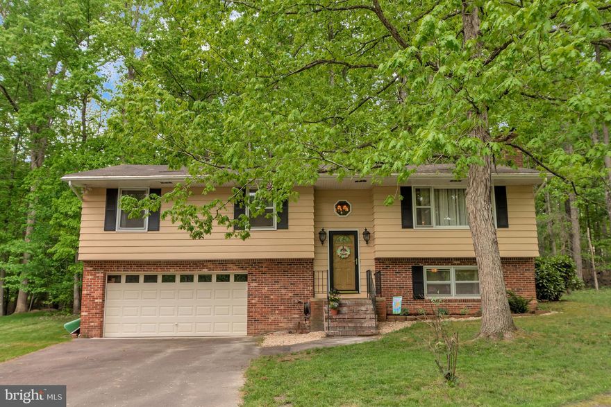 Welcome home to 3804 Lakeview where you will be pleasantly greeted by a spacious front yard of lush green grass.  Once inside you will be wowed by beautiful bamboo floors in the main living area, 2 fireplaces, gorgeous granite and stainless appliances in the updated kitchen and so much versatile space to truly make this house your home. Enjoy morning coffee on your private deck while enjoying the view of the 5th green through the trees. Need extra room to store all the water toys? You're covered! Not only do you have a nice shed in the back yard but wait until you see all the extra space in the over-sized garage. Feel like venturing out? You will be pleased to know that you are in walking distance to a beach! The community has so much to offer! A private, gated, secured community, Lake of the Woods offers anything and everything you could possibly want. Home to two lakes (the 550 acre main lake and a 35 acre "fishing lake"), a golf course, an equestrian center, a fire and rescue department, and a church all within the gates, Lake of the Woods simply has it all. Whether your passion is boating, waterskiing, kayaking, golfing, horseback riding, or simply taking in the breathtaking views from the clubhouse while enjoying a fabulous meal, from your own deck or yard, or from one of the beaches, you won't be disappointed! Perhaps you'd like a game of bridge or volunteering your time and talents...Lake of the Woods offers more than 60 clubs and/or organizations from which you may choose to become involved. Located in Orange County, we are fortunate to enjoy low real estate taxes. Coupled with home prices ranging from $100,000 to over $2,000,000, Lake of the Woods is the perfect community for both full-time residents, as well as weekenders. But don't take my word for it, please come see for yourself! I will gladly give you a tour of Lake of the Woods by boat and by car so that you may experience why I love Lake of the Woods!