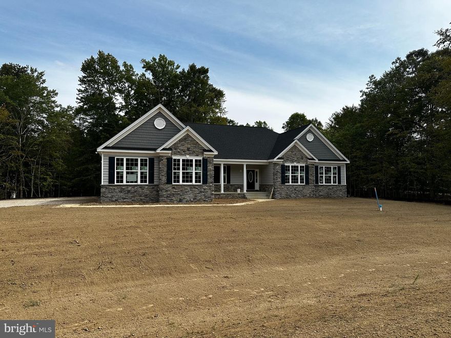 QBHI's popular Winchester on lot 32 Fischer's Grant. Features 4 bedrooms, owners suite with a cathedral ceiling, walk in closet and full bath. Bath has grand kitchen , pedestal tub, separate vanities.  Kitchen is upgraded with double wall oven, built in microwave, cooktop, large pantry, and kitchen table space.. plus a kitchen Island and breakfast bar.  Large family room with tray ceiling and gas fireplace. Basement has loads of finished space, wet bar, study, full bath, and walk up exit to the beautiful back yard.  Call to build your QBHI home today.