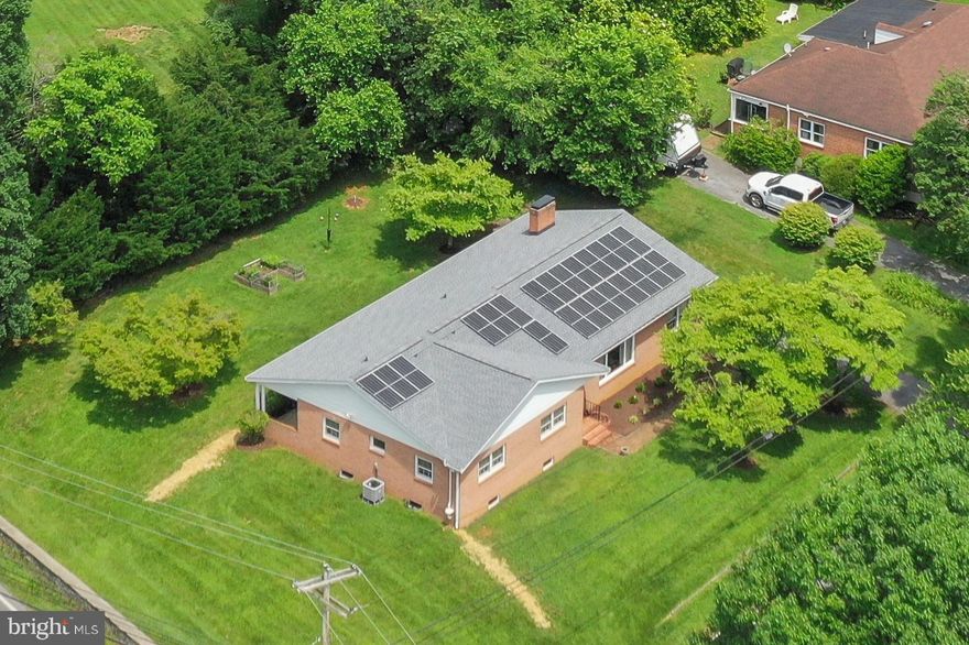 Owned Solar Panels, EV Charger, New Water Heater, Easy One-Level Living with Expansive Basement in Historic Shepherdstown

23 Fairmont Avenue is a solid all-brick ranch offering the simplicity of single-level living paired with the flexibility of a full, unfinished basement. Just minutes from downtown Shepherdstown, this home is perfect for buyers who value space, low maintenance, and energy efficiency.

Inside, you'll find hardwood floors throughout, generously sized rooms, and charming original details. The living room features a classic brick fireplace and rich wood paneling, while the dining room and kitchen retain vintage charm with thoughtful updates. Four bedrooms and two full baths provide comfortable living on the main floor, with no steps required.

Downstairs, the full unfinished basement offers endless potential — ideal for a workshop, hobby space, or serious storage needs.

Highlights include:

One-level living with 4 bedrooms and 2 full baths

Spacious full unfinished basement with interior access — perfect for a shop or studio

Newer heat pump HVAC system

Solar panels for energy savings

Electric vehicle charging outlet

Hardwood floors throughout

Two back patio spaces and mature landscaping

This is a rare opportunity for easy, efficient living in one of the Eastern Panhandle’s most walkable and vibrant towns. Just blocks to Shepherd University, coffee shops, restaurants, and the C&O Canal trail.