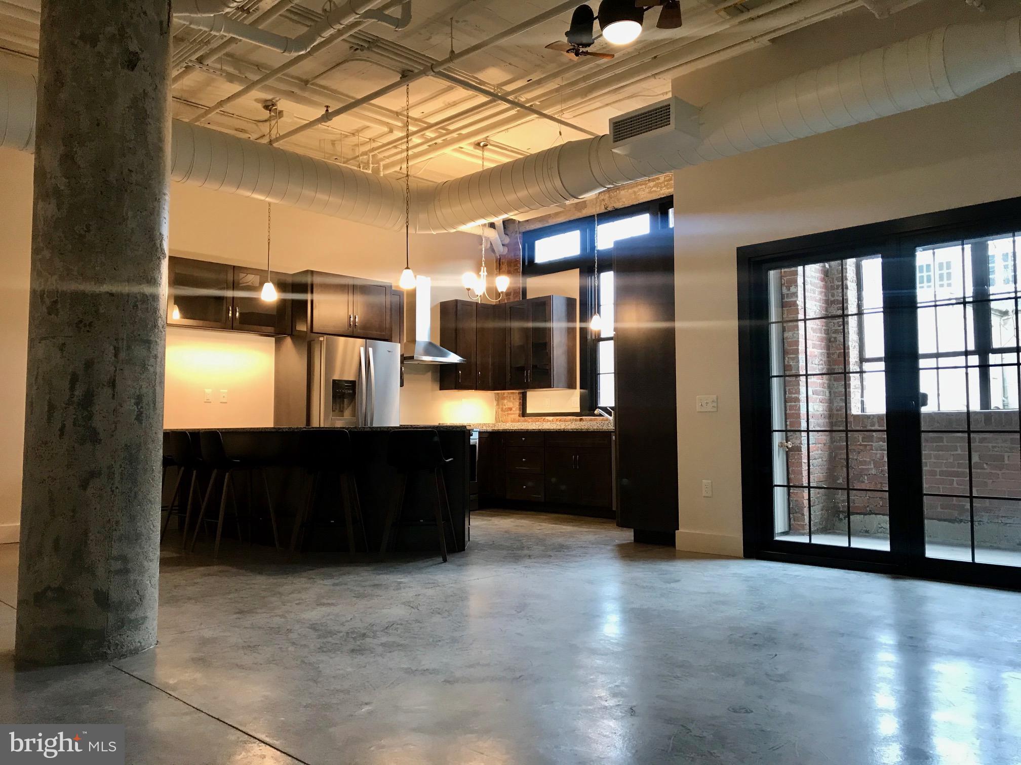 Be the first to live in this brand new, first floor, gorgeous, warehouse style condo! Just half a block to LGH with parking. This 2 bedroom, 2.5 bath offers an abundance of natural light in every room, high ceilings, private terrace with hose bib + electric (grill permitted), operable windows with blinds, wall-mount TV hook up in living and bedrooms, laundry room with brand new front load washer+dryer, chef's kitchen with large island, gas 5-burner stove, cabinets galore, tall pantry cabinet, under cabinet lighting + large breakfast bar with seating for 5 (stools included). The white ceilings, exposed brick and concrete beams give so much character! 2 parking spaces (1 indoor garage space and 1 surface steps from the front door). Each bedroom features an en-suite bathroom + ceiling light/fan. Blinds have been installed after photos were taken. There are 4 condos in the building. Available now/move in ready; 18 Month lease term preferred; Pet(s) allowed with landlord approval and additional deposit. Monthly Rent: $2,400 and Tenant pays electric, gas, water/sewer. Trash, taxes and condo fee included in rent. Applicants must pass a credit check and provide a gross combined income of 3x the monthly rent.