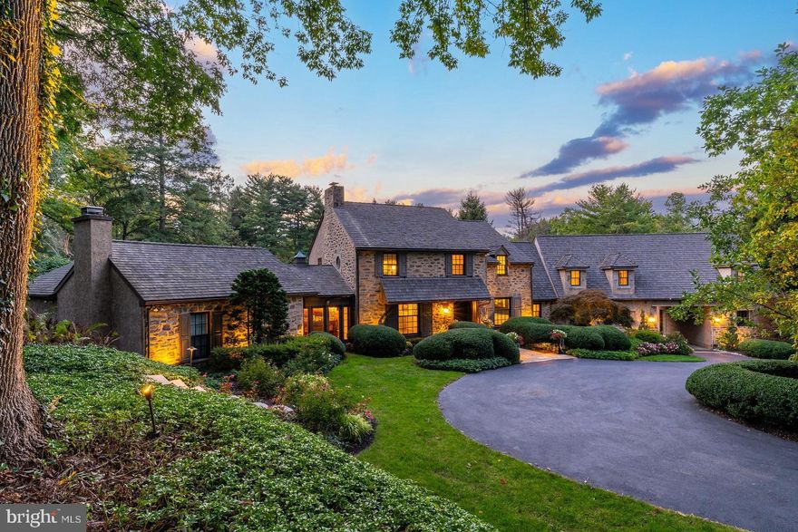 Presenting a truly exceptional Main Line estate nestled on 2.23 private acres in the heart of Villanova. Upon entering the center entrance hall, one is immediately struck by the bright, sunlit spaces, luxurious finishes and lovely views of the pool and rear grounds. A living room with gas fireplace and French doors to the rear terrace leads to the expansive primary first floor suite with fireplace, featuring 2 full baths, each with walk-in showers and one with a soaking tub, as well as two large walk-in closets with ample storage. The formal dining room off the center hall has an expansive pantry with plenty of built-in space, refrigerator, ice maker (2023), dishwasher, warming drawer, and access to the finished basement. The open kitchen and great room with vaulted ceilings are the heart of the home, providing the perfect space for smaller family dinners or more large-scale entertaining. The kitchen features a large island with bar seating, copper farmhouse sink, new (2023) stainless 48 inch range with custom backsplash, and French doors to the terrace. The great room has a wet bar with beverage fridge (2023), an impressive fireplace with carved stone mantle, and leads to the private, distinguished office/library with vaulted ceiling, wet bar with beverage fridge (2023), private powder room and carved wood fireplace. A private entrance to the au pair/in-law suite with bedroom, living room, bathroom and full kitchen is accessed off the kitchen. An additional walk-in pantry, laundry room with dog washing station and access to the garage with Tesla charger can be found in this section of the home. On the second floor is a large bedroom suite with new marble-tiled bath, two additional bedrooms and a full hall bath. The finished basement provides additional living and ample storage space. The pool (with new tile surround and coping) and grounds of this impressive property are truly a private oasis, with a lovely slate terrace leading to the pool house with full bath, extensive mature landscaping, and firepit – the perfect spot to sit in the evening watching the fantastic sunsets. Beyond, the large, flat lawn is the perfect venue for a game of football. A 3-car garage and whole-house generator complete this fantastic property. All this, and a superlative location with easy access to the train, 476, 76, Conshohocken, Bryn Mawr, and just 90 minutes to NYC.