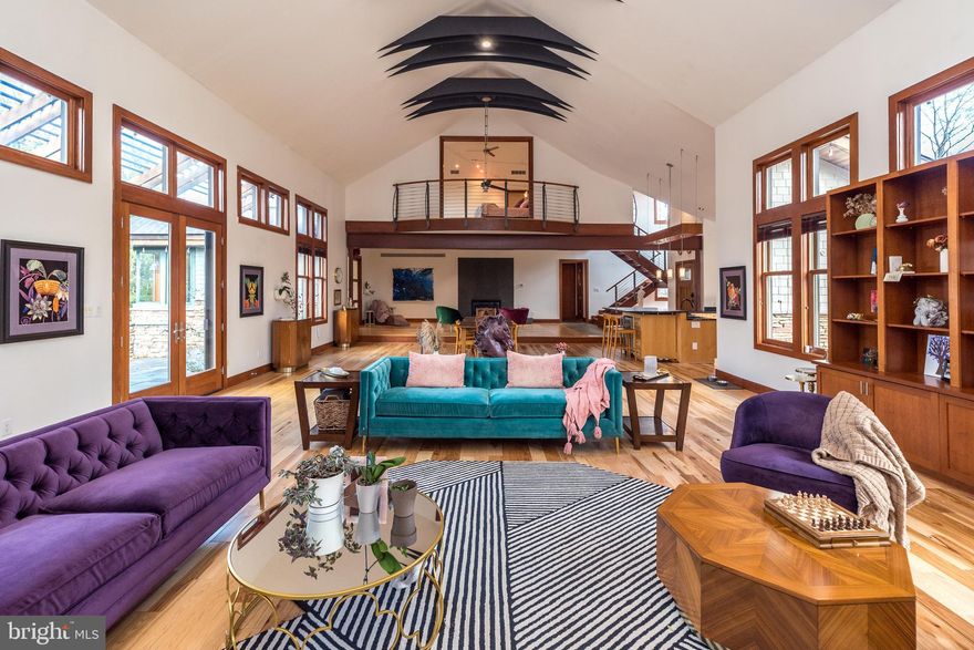 Acclaimed Modern Craftsman Home in Montgomery County, PA.  For the buyer who has an eye for elevated design and the flexibility to work from anywhere, this modern craftsman gem in Upper Salford Township, PA, may be your family’s dream home for generations to come. Tucked away on a cul-de-sac and a wooded 1.22-acre lot, this sprawling 5,146-square-foot home, designed by renowned local architect Phillip D. Kunz, has been written up in architecture books and magazines. With a view of a ski hill from the indoor pool, it gives the feeling of a remote mountain resort, yet it is only 45 minutes from Philadelphia International Airport and less than two hours from New York City.  A nature-lover’s or horse-owner’s dream, just ½ a mile from this home’s front door is the 22-mile Perkiomen trail, ideal for hiking, biking, or riding. The home features soaring ceilings, oversized industrial elements, and a dramatic balcony overlooking the main house from the second-floor master suite. From every direction, you’ll see that this home is intentionally designed with high-quality materials and rich in over-the-top details. The original house was built as an extravagant two bedroom with an indoor pool. The second owners brought back Kunz, the original architect, to oversee the design and addition of an expansive guest wing with a hallway of exquisite closets, finished with cherry and rice paper sliding doors, bringing the house to four large bedrooms and 2 ½ high-design bathrooms. The house has been used as an artist’s residence for a Canadian writer for the last two years and is back on the market after a main floor renovation, focused on the removal of room dividers and suspended cabinets in the main house to open it up in a great-hall manner. One hundred square feet of stunning soapstone countertops have been added in the newly expanded kitchen. The original main floor carpet has been replaced with a high-contrast hickory that complements the cherry craftsman details while preserving the original bamboo floor border, staying true to the original owner’s vision of a craftsman-style home with contemporary, eastern influences throughout.  With the main house built in 2006, and consistent updates over time, this house expands with the vision and improvements of each owner, including a 2014 addition of a 1200 square foot guest wing, a 2018 master bathroom remodel, a new roof in 2019, a 2022 update of the indoor endless pool, a 2023 kitchen expansion with upgraded countertops, and new main house flooring in 2023. Experience high style in a charming town—at just a fraction of the cost a home of this pedigree would command most anywhere else in the country. Enjoy resort-like amenities, including radiant heated floors throughout, a heated pool and hot tub, all while being surrounded by nature and privacy. With award-winning schools, local shopping, and dining nearby, plus easy access to Philadelphia and NYC, this home offers freedom, beauty, and space, with convenient access to the hustle and bustle of the city.