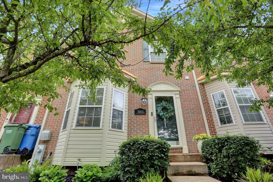 Multiple Offers Received. 
Welcome to 3061 Raking Leaf Drive, a stunningly updated and impeccably maintained brick-front townhome nestled in the charming Autumn Run community. This inviting home boasts a thoughtfully designed, open floor plan that creates an ideal space for both relaxation and entertaining. As you step inside, you'll immediately be drawn into the spacious living room, where soaring 9-foot ceilings and a large bay window flood the space with natural light, making it feel airy and welcoming. The heart of the home is the expansive kitchen, featuring an abundance of elegant cherry cabinetry, sleek granite countertops, and an updated backsplash that adds a touch of sophistication. The kitchen is not only functional but also stylish, with a convenient central island, a generously sized pantry, and a cozy dining area perfect for casual meals or entertaining guests. From the kitchen, a beautiful sitting area leads to a private deck, where you can unwind and enjoy the peaceful view of the fenced-in backyard that backs up to trees. Upstairs, the oversized primary bedroom offers a true retreat, with a spacious sitting area perfect for reading or relaxation. Two walk-in closets provide ample storage, and the luxurious ensuite bath is an oasis in itself. Featuring a deep soaking tub, a separate stall shower, and a double-sink vanity, it’s the ideal spot to unwind after a long day. The upper level also includes two additional bedrooms and a full bathroom in the hall, ensuring comfort and convenience for all. The lower level is equally impressive, with a vast family room that serves as a versatile space for recreation or relaxation. This level also includes a convenient half bath, a utility room with laundry, and a workbench area, making it perfect for any hobbyist or DIY enthusiast. Located in a prime spot, this home offers easy access to military bases, major highways, and a variety of shopping options, ensuring that everything you need is just a short drive away. Whether you're looking for a place to unwind or a space to entertain, 3061 Raking Leaf Drive is a perfect blend of comfort, style, and convenience.