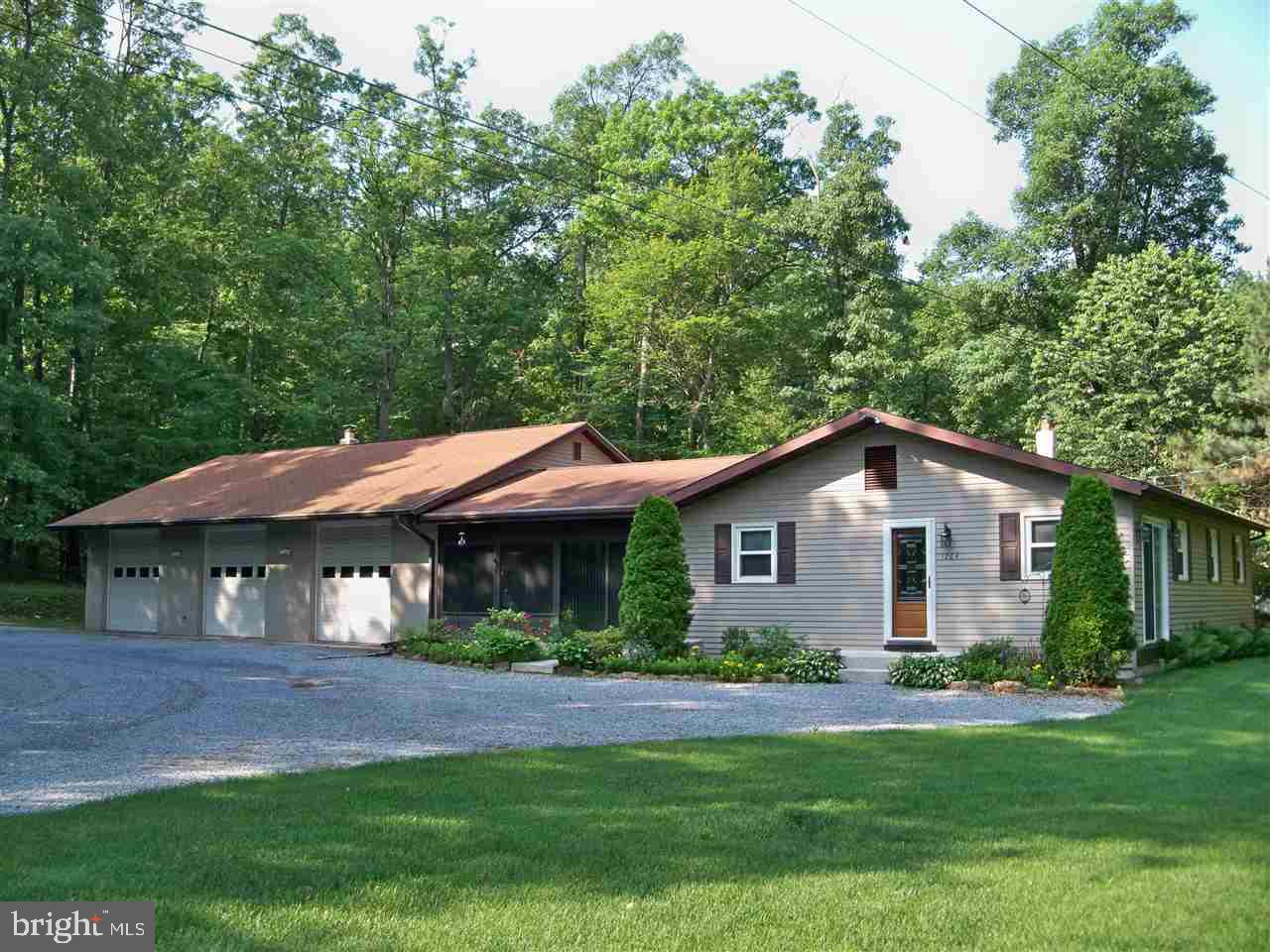 Immaculate, updated ranch home on 2.03 wooded acres. The home features an eat-in kitchen, living room, 3 bedrooms and all season enclosed family room. For the hobbyist, there is a 30x45 3 car, 2-story garage with a wood stove for all-year "tinkering." Home has a gas fireplace as well as a coal/wood stove to help with heating costs. Newer central air, hot water heater and replacement windows and an above ground pool.