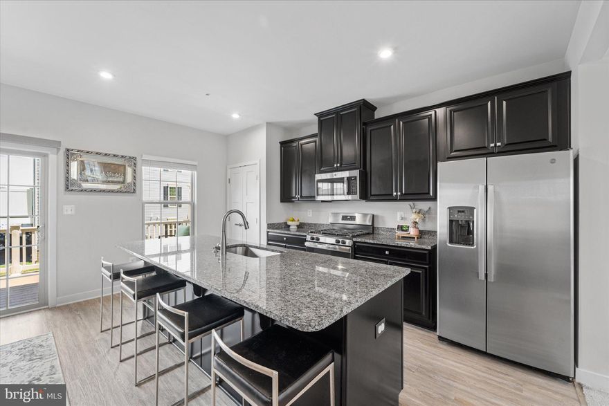 *****HOME LOAN IS ASSUMABLE ( VA AT 2.99%)*****

No need to wait on new construction! This exceptional Mozart model is ready for you and comes at a price lower than the builder's current rates for similar properties in the community. Don't miss out on this incredible opportunity to experience luxury living! Welcome to 8104 General Armstrong Avenue! This luxurious townhouse offers over 1,700 square feet of living space across three levels and features a host of tasteful upgrades throughout. This spotless home shows like a model.
Step inside and you're greeted by a modern, chic foyer, complemented by a recreation room, a half bathroom, and access to the 2-car garage. The second level is bathed in natural light from countless windows, creating a bright and airy atmosphere. The open-concept floor plan seamlessly combines the living and dining spaces, making it perfect for entertaining family and friends. The gourmet kitchen is a haven for food enthusiasts, featuring upgraded granite countertops, sleek stainless-steel appliances, dark espresso cabinets, and a massive island that comfortably seats multiple people. This level also includes a half bath and a spacious Mahogany composite deck with vinyl railings and privacy barriers.  On the third level, you'll find the owner's suite, complete with a large walk-in closet and an ensuite bathroom equipped with dual vanities and a spa-like shower. Additionally, two secondary bedrooms share a full bathroom and a laundry room. 
The community is commuter-friendly and fosters an active and welcoming atmosphere. It is walkable, full of open areas, and adjacent to recreational facilities. The location is everything! Enjoy numerous dining experiences, retail establishments, and cultural attractions just minutes from Joint Base Andrews, the National Harbor, and much more.