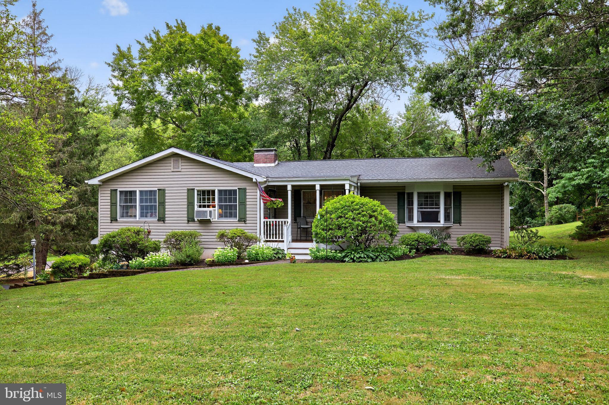 Welcome to this charming one-story Ranch in Solebury Township, set on just over a half-acre in the sought-after New Hope-Solebury School District. Just a couple of miles from the shops, dining, and riverfront activities of New Hope’s vibrant Main Street, this property combines convenience with a peaceful setting. The home offers 3 bedrooms, 2 bathrooms, and a one-car garage. A covered front porch welcomes you inside to the spacious great room, featuring a brick-front wood-burning fireplace, exposed beams, and built-in cabinets. The kitchen is brightened by a skylight and offers wood cabinetry and recessed lighting, with an adjoining dining area enhanced by crown molding and wainscoting. The primary bedroom includes a bay window with a window seat and storage, generous closet space, and a private en-suite bath with a double vanity. Two additional bedrooms share a hall bath. The partially above-grade lower level is mostly finished, providing extra living space along with the laundry area. Hardwood floors lie beneath much of the carpeting, offering the opportunity to add timeless warmth and character. The backyard features a wood deck and storage shed, ideal for outdoor enjoyment. Practical updates include a brand-new septic system and a roof only a few years old. Set in a prime Solebury location near the heart of New Hope, this one-story Ranch is a special opportunity not to be missed.