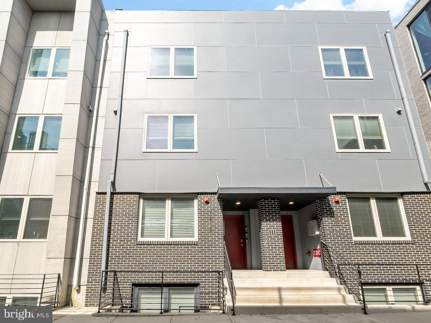 Welcome to 1818 N Front Street, Unit B — a spacious and stylish 1,380 square foot bi-level condo in one of Philadelphia’s fastest-growing and most walkable neighborhoods. This 2-bedroom, 1.5-bath residence features elevated finishes, smart design, and shared pilot house access to a roof deck with panoramic city views.
The open-concept main level boasts durable ceramic tile flooring, tall ceilings, and oversized windows that bring in abundant natural light. The modern kitchen includes quartz countertops, custom cabinetry, a designer tile backsplash, and high-end stainless steel appliances. A raised seating edge on the island makes for a perfect eat-in dining setup — ideal for entertaining or daily living.
Upstairs, two spacious bedrooms offer great separation and generous closet space. The full bathroom is outfitted with sleek fixtures and contemporary tilework, and the main level also includes a stylish half bath, in-unit laundry, and central air.
Enjoy access to the shared pilot house and roof deck, perfect for lounging, working outdoors, or enjoying the sunset. Located just steps from the Berks El station, this home offers direct, rapid access to Center City in minutes. Fishtown, with its acclaimed dining, coffee shops, galleries, and nightlife, is right around the corner. Plus, with a Walk Score of 92, you'll love how easy it is to get around without a car.
This is urban living at its most convenient — and most exciting.