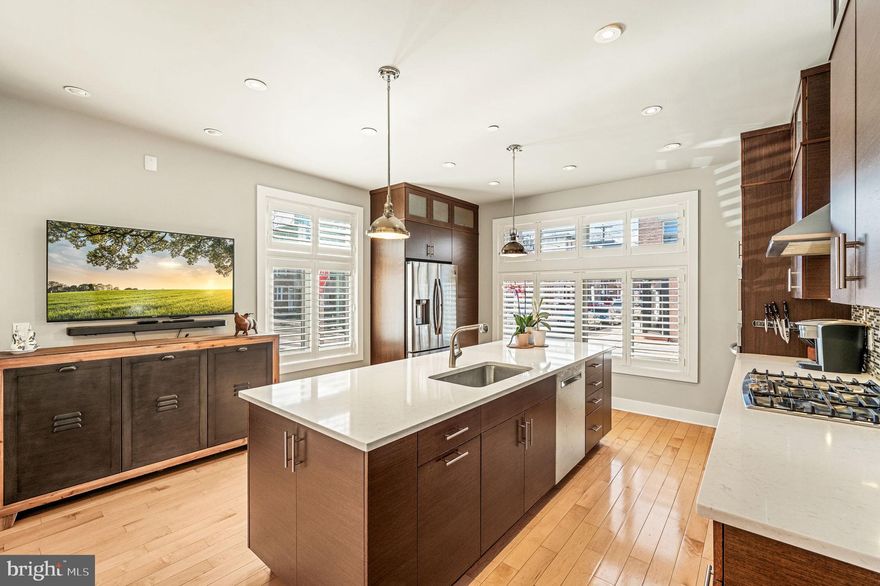 Quintessential corner in Catharine Court! 771 S. 19th St is a luxurious 3 bedroom 2.5 bath home in the heart of Graduate Hospital. Step inside this inviting home through the private entrance on Catharine Street or directly from the garage. As you enter, you’re greeted by an abundance of natural light that dances throughout the home, creating a warm and comforting atmosphere. The open kitchen is outfitted with stainless steel appliances including an LG 5-burner gas stove & Bosch dishwasher, ample cabinet space, pantry closets, an oversized quartz island, and a separate dining area. The living room overlooks the dining area and features beautiful custom built-ins, an electric fireplace, and a deck. The primary suite accommodates a king-size bed and includes hanging and walk-in closets, large windows, and an ensuite bath with a soaking tub, vanity, step-in shower, private commode, and linen closet. The second and third bedrooms offer ample closet space and great light while the additional full bath showcases a skylight.  A convenient laundry room on the top floor features a new Maytag stacked washer and dryer and a sink. Ascend to the rooftop deck boasting breathtaking skyline views. The finished basement is perfect for entertaining with a wet bar, a built-in wine cooler, a linen closet, and powder room. Additional highlights include hardwood floors, recessed lighting, plantation shutters, Hunter Douglas Blinds, California custom closets, and 2-zoned HVAC. Located just blocks away from Center City, Graduate Hospital provides access to a vibrant array of dining experiences, including favorites like Loco Pez, SideCar, and Illata. With close proximity to Rittenhouse Square. Penn and CHOP, residents enjoy unparalleled convenience alongside a dynamic urban lifestyle. Easy access to public transportation and 76 ensures seamless commuting making this neighborhood an ideal choice for those seeking accessibility and community.