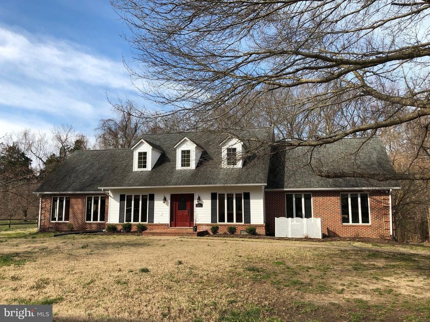 Cape cod in Breton Bay with main level bedrooms.  Freshly painted, Refinished hardwood floors, new carpet on main level.  Open family room & kitchen. Sunroom.  Oversized garage.  Shed.  Water view lot.