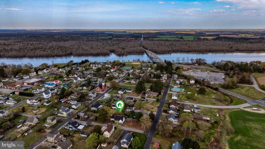 This charming in-town home is ideally situated on a desirable corner lot, just a short walk to Cherry Beach and public boat ramp access—perfect for boating enthusiasts looking to explore the waterways.   Enjoy the Eastern Shore lifestyle with easy access to fishing, water sports, and scenic river views.

The home features 4 well-appointed bedrooms, including a 3 convenient entry-level bedrooms for ease and accessibility. The bright and inviting main living area is anchored by a timeless brick fireplace, creating a warm and comfortable space for everyday living.

The eat-in kitchen offers abundant cabinet storage and a functional space for casual dining and entertaining. 

A daylight, partial basement with interior access and walkout capability provides excellent versatility—perfect for additional living space, a recreation area, workshop, or storage. 

Outside, the expansive corner lot offers plenty of room for outdoor enjoyment, gardening, or future possibilities. Both on-street and off-street parking are available, with a private driveway providing added convenience.  Home also features a carport.

Meticulously maintained and full of character, this five-bedroom home presents a rare opportunity to enjoy comfort, flexibility, and a prime location just steps from Cherry Beach and boating access.