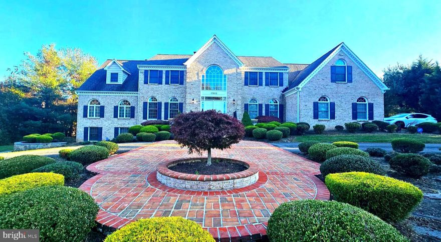 Amazing custom-built over 8,000 sq ft brick Colonial with 5 bedrooms, 4.5 baths and 3 car garage on a 1.8-acre lot. Countless upgrades throughout. Gourmet Kitchen with Viking professional appliances and large Breakfast Room; Great Room featuring stunning stone fireplace; Banquet Dining Room with extensive architectural molding; Huge Living/Social Gathering with expansive views and French door access to deck and flagstone patio; Home Office on main level; Generous Master Suite includes a Sitting Area with wood burning fireplace, luxury en suite with huge walk-in closet and Electrolux washer & dryer laundry space with storage; Open concept expansive lower level has fully equipped kitchen, two additional bedrooms, full bath and Recreation room with wood burning fireplace ---All this on a quiet street close to ICC MD 200, Shady Grove MetroRail Redline, Rock Creek Park, Lake Needwood Boating, Olney shopping and more.----------------Grand 2 story reception foyer with double door entryway and side lights welcomes you with marble flooring, decorative shadow boxes, chair rail and crown molding. Two conveniently located coat closets and architectural arches throughout main level add to the charm. Living room continues detailed millwork with chair rail and crown molding and ceiling medallion. Banquet sized Dining Room has ceiling medallion and extensive architectural moldings. Huge Living Room/Social Gathering boasts a wood burning fireplace and 2 sets of French doors leading to rear yard.3rd set of French doors opens to the well appointed Home office. Gourmet Kitchen has large center island with granite countertops, all Viking professional appliances large double-door refrigerator, 6 burner gas cooktop in island, 2 dishwashers, beverage refrigerator, double oven and microwave -- double sink, and attractive ceramic tile backsplash. Breakfast area and separate breakfast room boast a wall of windows, 5 skylights, and French doors to the Trex screened in porch with eye-catching tray ceiling accented with glass block windows, recessed lights and large ceiling fan. Great Room off kitchen is highlighted by the impressive raised slate hearth floor-to-ceiling stone fireplace, with decorative molding, vaulted ceiling, wet bar area with wine glass storage & granite countertops, Palladium windows, and large storage area completing the room. Light and bright Family Room on opposite side of kitchen has 8 skylights (2 w/remote openers), custom built-ins for TV/sound system/storage, and sliding French door leading to the screened in porch, deck and large flagstone two-level patio. Convenient Butler s Pantry area offers an abundance of storage and desk area. Adjacent Mud Room includes a utility tub and additional coat closet and offers access to the 3-car garage with upgraded modular flooring. Upstairs landing affords a dramatic overlook into Great Room below. Master Bedroom has columns & arches, recessed lighting, architectural molding and Sitting Area with attractive marble wood burning fireplace hearth & surround. Luxury suite Bath has French door entry, marble counters, dual vanities sinks, separate shower, window seat, circular soaking Jacuzzi tub, dual linen closets, two walk-in closets -- 1 large with built-ins & attic access, and 1 with Electrolux W/D & storage. Separate water closet contains a bidet, toilet & sink. Bedroom 2 is a junior suite with vanity, ceramic tile and tub. Hall includes ample storage with dual linen closets. Bedroom 3 connects to the Jack & Jill bath. Spacious Au Pair suite includes a separate bedroom with 2 closets, entrance to the Jack & Jill bathroom, and expansive living area with Palladian window and back stair access to main level.