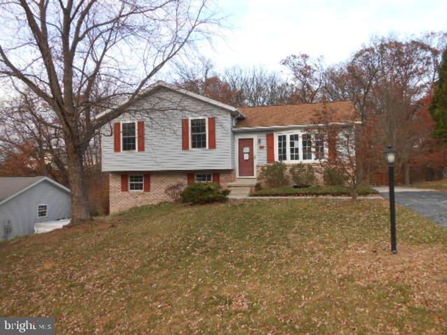 Build sweat equity! Conveniently located home, backing up to Young's Park, and woods, you will enjoy the privacy this 3 Bd Rm, 2 1/2 Bath split-level home has to offer. Featuring: a Large eat-in kitchen with 2 sinks, and slider to a deck and private backyard. Master Bath with Ceramic Tile floor,Rec Rm with slider to back patio, storage area's, Off street parking. Replacement windows throughout. Sold in AS IS condition seller will make no repairs.