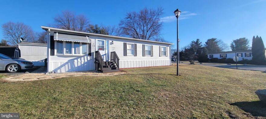 3 Bedroom, 2 bathroom double wide on a corner lot with a paved driveway located at Lakeside Park. Home has a front porch, bay window in living room, shed for storage and a covered rear deck for entertaining. Buyer to be approved by Park management.  Lot rent covers taxes, trash, snow removal and pool/fitness center.