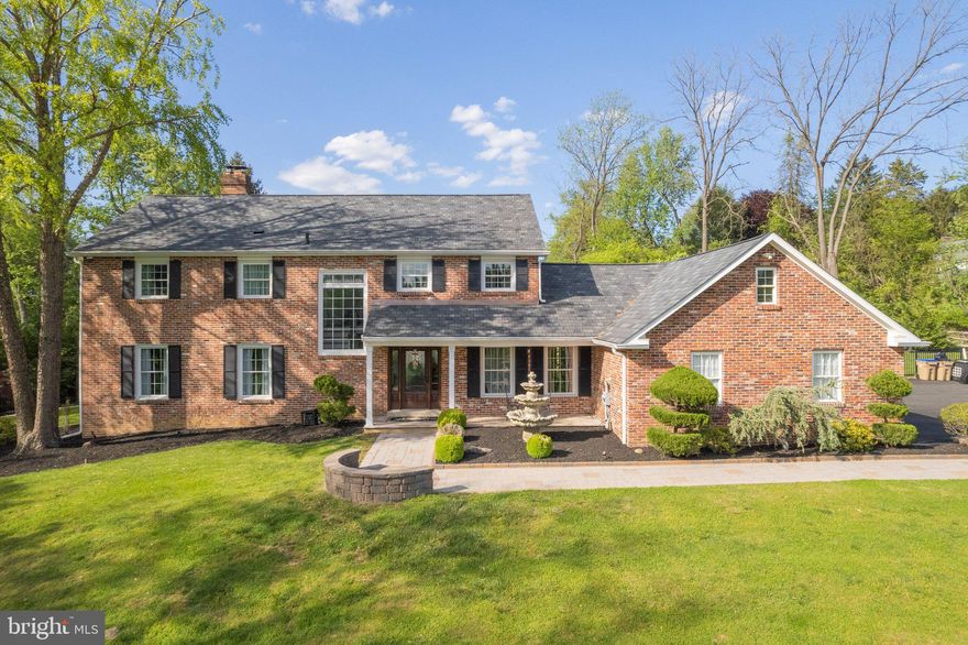Welcome to 4105 Goshen Road, an absolutely stunning brick home blending a lifestyle of luxury and convenience with all the features and amenities you could imagine, while being just minutes from all your everyday needs in growing Newtown Square!  This 4 bedroom, 2.5 bath home sits on an idyllic 2.35 acre lot and is pristine in every facet from the inside-out.  This home’s stately curb appeal lures you in with immaculate landscaping, incredible hardscape detail, and a lovely paver walkway.  A charming front porch is finished with Travertine tile and leads you into the foyer making you instantly feel at home, with elegant features from the rich flooring, decorative handrails up the staircase, intricate moldings, and seamless flow into the formal living and dining rooms.  Exquisite Patagonian Rosewood flooring spans much of the main level and is complemented by the soft wall colors throughout.  Enjoy hosting large gatherings in the sprawling kitchen brimming with endless features; the Travertine tile floors are heated, custom cabinetry allows for endless storage space, and the stainless appliances are suited for any culinary enthusiast with a SubZero® refrigerator/freezer, a 6-burner Wolf® gas cooktop, and Wolf® double wall oven!  Additionally this kitchen features a unique and exquisite range hood that frames a focal painted landscape just above the cooktop, beautiful granite countertops that flow into a tiered center island that comfortably seats up to 6, 2 copper hand-hammered farmhouse sinks, a wine fridge, hidden outlets located under the cabinetry, and lovely arched doorways accented by stone.  Off of the kitchen is a cozy family room/den perfected by built-in bookshelves, a dual sided fireplace that is situated between this space and the formal front living room, and most importantly, allows an easy transition to the incredible backyard and covered patio.  Easily transport guests to the outdoors to relax on the covered patio with a 55-inch flat screen outdoor TV with surround sound, a massive Travertine tile patio bordered by custom retaining walls and a gorgeous outdoor fireplace, and the truly remarkable 20x40 salt water pool finished with gunite and elegant water fountains.  The view from the patio is unparalleled to anything you will see on the market with tiered and stacked boulder retaining walls with steps that lead up to a large garden shed to store all your outdoor equipment and garden tools.  Be prepared to be the favorite house to hang out at with a giant sport court built for playing basketball, tennis or pickleball and is set up with outdoor LED lights for night-play!  Head indoors and end long days by ascending to the upper level to find a relaxing oasis in the primary suite boasting Rosewood hardwood floors, a vaulted ceiling, and access to the private veranda surrounded by a custom wrought iron railing, all overlooking the most amazing views of the pool, tiered hardscapes and private surroundings. The attached en suite bath has been enhanced with rich Travertine tile, a granite-topped dual vanity, and a small makeup/vanity area.  The additional 3 bedrooms all offer plush carpet, spacious closets, and share a beautifully remodeled hall bath.  Additional noteworthy upgrades include a fully-finished lower level, newer roof with architectural shingles (2021), geothermal heating and A/C, new garage doors, a newly installed water filtration system, 15 new double-hung windows, added insulation on the 1st floor as well as attic & garage, a newer driveway widened to park 12+ cars, and so much more!  Act fast, this incredible home is not going to last long with its endless list of features you won’t find in any other home!