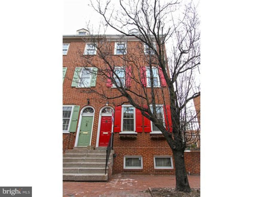 This stunning brick front property, with over 2,400 sf of space, has 3 bedrooms 2.5 baths, with 1 car deeded off street parking (parking space 1) and is located in Society Hill on the cusp of Washington Square West. This location speaks for itself being called a "Walkers Paradise" with a Walk Score of 97! The interior is equally impressive. Enter in to a marble tile foyer with cathedral height ceiling and to the right an enormous walk in closet with built in shelving. Step up to the loft style dining room that overlooks the family room below. 2 stories of the rear of this home has been transformed into an impressive 20+ft Glass Atrium with inspiring views of a private brick garden patio and open to sky views. This atrium can be enjoyed from the dining room as well as the family room below. Enter in to the contemporary kitchen through a beautiful Art Deco custom glass stained solid wood door. The kitchen features stainless appliances,5 burner gas range, modern glass tile back splash, a built in pantry with pull out drawers, and plenty of granite counters to work with. The lower level is an extremely large family room filled with natural light from the atrium  and there is a lovely wood burning fire place with a handsome marble base. The powder room and laundry room are also located on this level. You'll notice as you tour this home that there are recessed lights and hard wood floors in pristine condition throughout. The open solid wood staircase and iron stair rails will lead you up the the next level where 2 large bedrooms are separated by the shared bath. Each room has plenty of closets and there are even extra closets in the hall. The upper most level is the master bedroom suite. At the top of the stairs there is an open flex space, an Orchid Room with French doors, and roof top views. The master bath is located on this level as well and has a large vanity with dual sinks, granite vanity top, and a glass enclosed shower. The master bedroom facing Lombard includes built in cabinetry for storage as well as a walk in closet and hall linen closet. Amazing home in a fantastic location. Parking located to the immediate right of the home in the private parking lot.  Also, small park/garden down the cobblestone alley at the end of the row homes is uses by all the residents on the block.