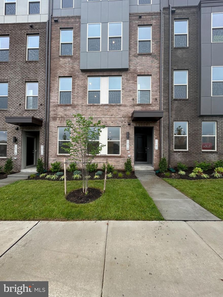 Welcome to 9070 Katherine Johnson Ave at Innovation Town Center - Experience Life Perfectly Designed to Fit Your Lifestyle -This brand new 3 bedroom, 2.5 bathrooms townhouse is more than just a home—it's where modern living meets convenience and comfort. Imagine seamless entertaining and everyday living with its thoughtful, open-concept design. Whether you're hosting happy hour or lounging on the couch for a casual dinner, this spacious layout is perfect for both. The heart of the home, the kitchen, is beautifully showcased with a stunning quartz island. Perfect for appetizers during gatherings or even as a work-from-home spot for quick meals, this is what dreams are made of. Flooded with natural light, the kitchen blends effortlessly into the main family room, creating a warm, inviting space you and your guests will love. Enjoy ultimate relaxation in the oversized primary suite. It’s equipped with two walk-in closets, and an en-suite bathroom with double vanities. Your primary suite is your private haven, designed to meet all your needs. Enjoy the upper-level balcony, ideal for morning coffee or unwinding after work. The two secondary bedrooms are of generous size as well. Upper level laundry for added convenience. This stunning townhome has a 1-car, rear-load garage with built-in storage options. Use the space to stash your tools, sports equipment, or other essentials—all neatly organized and within easy reach. More Than a House—It’s a Lifestyle -At Innovation Town Center. So conveniently located, right next to George Mason University - Science and Technology Campus in Manassas. Rt 234 bypass, rt. 66, rt. 28 and rt. 29. Shopping, restaurants and grocery stores are just a few minutes away. Don’t miss this one!