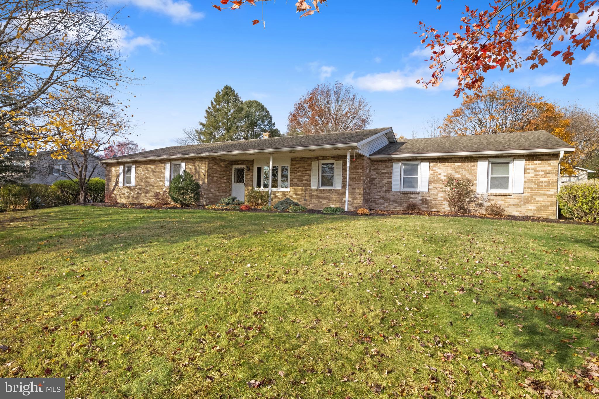 Welcome home to this nearly 2000 sf  full brick ranch home on a spacious 1.60 acre lot.   Big rooms complement the functional floor plan with 3 or 4 bedrooms, large country kitchen,  main level laundry,  and a sun room for enjoying morning coffee and evening sunsets.   Finished lower level with another 1600sf finished area with 24 x 26 family room, built-in wet bar, large game room area and 1/2 bathroom, plus large storage and utility room.   Oversized, two car, side entry garage and a large detached garage with electric.    Recent improvements include architectural shingle roof, windows, heat pump all within the last 10-12 years.   Supplemental coal/wood stove integrated into heating system, full coal bin,   whole house generator, gun safe, patio awning, whole house fan,  and all appliances convey.  Needs interior updating but beautiful spaces inside and outside  to enjoy while updating.  Professional photos coming soon, seller is in the process of moving out.