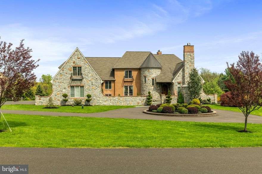 Custom Luxury Home located in Stoneymead, one of the most prestigious neighborhoods in Buckingham Township, Bucks County. Enter this French Tudor complete with turret and rustic alder door, and a courtyard straight out of Tuscany. Once inside the welcoming foyer you will notice the spiral staircase and a French door courtyard walk out in the dining room. The living room has a natural stone 18 ft. fireplace and adjoining study with wet bar. At the heart of the home is the Italian limestone floored kitchen complete with a Bertazzoni 6 burner stove and a large island with exotic quartzite. Next to the kitchen is a breakfast room, a family room separated by a stack stone see-through gas fireplace and access to a large composite deck which over-looks a bucolic gentleman’s farm. Upstairs there are 5 bedrooms and 4 bathrooms. The master suite has a gas fireplace, deep cast iron tub, large walk-in stack stone shower, 2 dressing rooms and sitting room. The lowest level has a completely finished 2000+ sqft. walk out basement with travertine floors, a 1920’s themed bar inset with an 1841 antique post office, wine cellar/grotto, fitness room, office, pool table area and a full bathroom. The French doors lead out to the bluestone patio with salt-water spa and pool. Built with some of the finest specimen stone countertops and floors, complete with an oversized 4-car garage and whole house generator. Many panoramic views throughout the house on this flat 2.32-acre property with many updates since it was built in 2012.