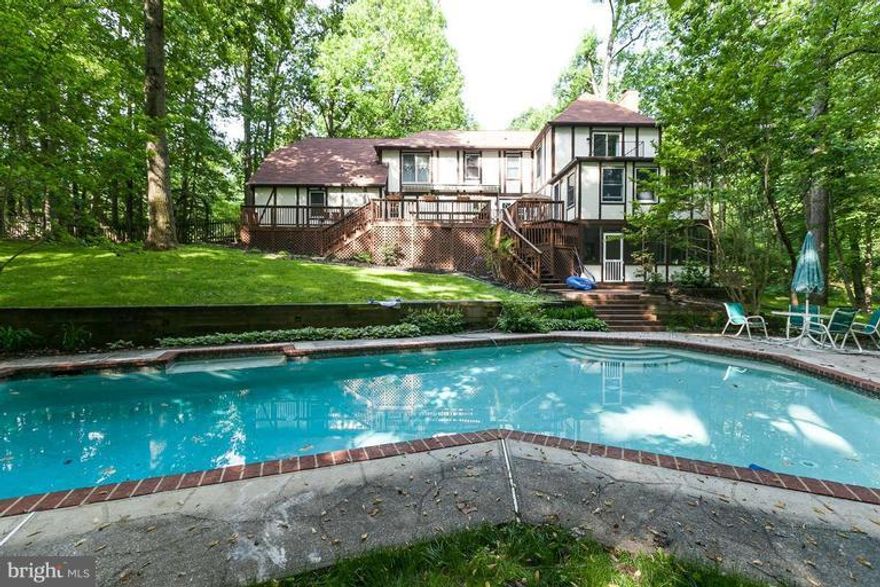 BRING ALL OFFERS! NEWLY RE-done bathrooms!Breathtaking views at every window of the 2+ acre gorgeous lot!! Welcome to 4000 SF of amazing potential and living space. Private yet close to everything, Updated Kitchen with beautiful appliances and open floor plan. Hardwoods cover entire main level, fully finished lower level that walks out to pool & patio.  PRICED TO SELL!