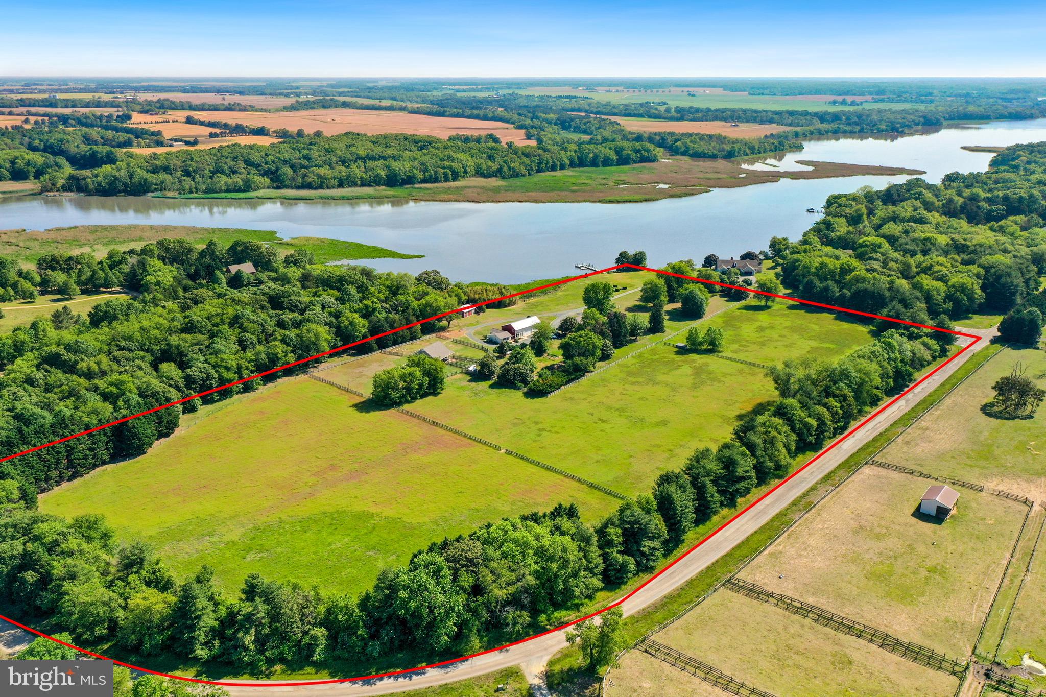 Welcome to Pheasantfield Farm, a 21- acre equestrian estate beautifully nestled on the Chester River.
Fantastic location, ample privacy, and yet only a short drive, or boat ride, to historic Chestertown. The main home boasts 4 bedrooms and two and a half baths. The primary bedroom has a lovely view of the river, two walk-in closets and a large attached full bath. The spacious ranch-style home offers plenty of space for entertaining. Enjoy meals on the front porch, overlooking the Chester River.
Additionally, there is a guesthouse with a kitchen, living area, bedroom and full bath. A short distance from the main home you will find the fully equipped horse barn. Completed in 2003, this barn has been exceptionally maintained. The barn offers 3 stalls, a tack room, sliding doors with glass windows, and a hayloft. The stalls open to the large fenced pastures, perfect for rotation.
While not on the farm, enjoy exploring the Chester River! The private dock includes an electric boat lift, floating dock, and sun or swimming deck. Spend evenings watching the sunsets on the sundeck or easily launch a kayak off of the floating dock.
Additional features include a 4-car garage with a loft, potting room or workshop, upstairs storage or office space and a pole barn to accommodate farm equipment.
Discover the many possibilities of Pheasantfield Farm, an exceptional waterfront escape in Queen Anne's County!