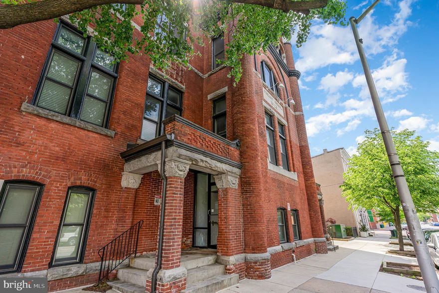 Most beautiful unit in a Baltimore landmark in the heart of Fells Point. Public school N 25 is a historic late Victorian brick structure with an imposing Romanesque tower. Unit 205 is facing the back of the building, providing character, cool courtyard views, no street noise and plenty of sunshine and shade at the same time! The original pine floors, high ceilings and tall windows give such elegance to the unit, while the updated kitchen and exposed ductwork provide a hint of industrial chic. Hot location! Open your windows and smell the fresh H&S bread baking across the street.  Situated around the corner from Broadway Market, a couple of blocks to Harbor East attractions and from Fells Point waterfront. Worried about parking? No need to be, the permit for a spot (#16) on the  500 block of Bond is only $20 for 60 days, and spots can also be rented at a local station for $100/month. Pets are allowed, and the fenced patios are ideal to walk your furry friends.
The tenant's lease will end on September 10th.