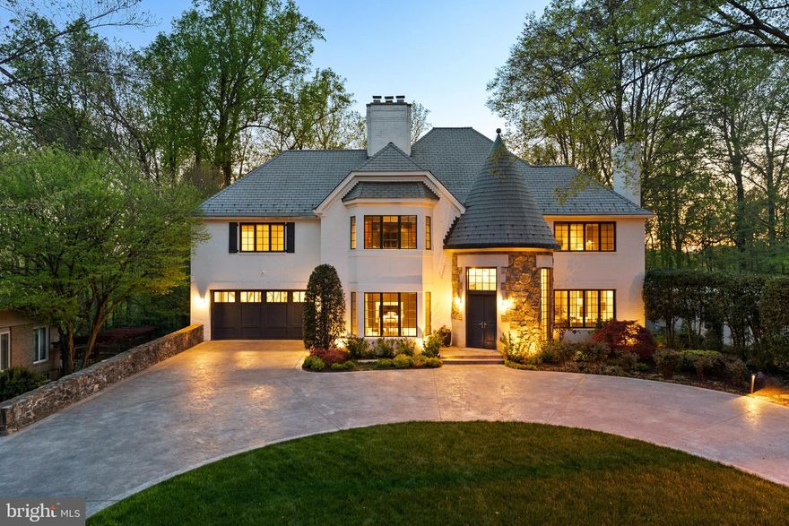 Welcome to a truly exceptional, fully reimagined estate set on a private half-acre in the heart of Bannockburn Estates. Spanning over 7,300 square feet across four impeccably designed levels, this rare offering is a seamless expression of architectural presence, elevated design, and resort-caliber living. A painted brick exterior, slate roof, and two striking turrets establish a sense of timeless distinction—an arrival that feels both grand and enduring.

With 5 bedrooms, 6.5 baths, and a dedicated office, the home is thoughtfully composed for both everyday living and sophisticated entertaining. Gracious proportions, curated materials, and a refined sense of flow create an environment that is as functional as it is beautiful, where each space unfolds with intention.

The kitchen is a study in precision and performance—anchored by a full suite of Miele appliances, including built-in espresso and steam systems—paired with custom Bulthaup cabinetry that delivers a clean, architectural aesthetic. Leathered stone surfaces introduce warmth and tactile depth, while a Wolf gas range with integrated griddle ensures professional-grade capability. Every detail has been considered, resulting in a space that feels both effortless and exacting.

The main level balances scale with intimacy. A formal dining room and elegant sitting room—each centered around a fireplace—set the tone for refined gatherings, while designer wall coverings and bespoke lighting lend richness throughout. A dedicated music room and private office provide moments of creativity and retreat. The home’s architectural character reveals itself in the circular turret foyer and the rear circular sitting room, where natural light enhances the home’s sculptural quality.

Upstairs, four en-suite bedrooms offer exceptional comfort and privacy, anchored by a remarkable primary suite that lives as a true sanctuary. Multiple Poliform closets provide tailored storage, while a private sitting room with fireplace and wet bar creates an intimate, residential retreat within the home. The 2023 primary bath, designed by acclaimed DC designer Jo Ireland, is both serene and striking—featuring a sculptural soaking tub set within the turret, fluted wood detailing, and a spa-inspired atmosphere that elevates the everyday.

Outdoors, the experience is equally compelling. Backing to mature trees, the grounds unfold into a private retreat designed for both relaxation and entertaining—featuring an infinity-edge pool with waterfall and hot tub, a stone-built Kalamazoo outdoor kitchen with integrated grill and Green Egg, and a full sport court. Retractable awnings extend the usability of the outdoor spaces, while irrigated garden beds add both beauty and purpose. A heated circular driveway and attached two-car garage with EV charging ensure ease in every season.

Inside, hydronic heated floors run throughout, complemented by a fully integrated smart home system controlling lighting, shades, and audio/visual as well as a whole whole generator—quietly enhancing daily living with intuitive precision.

The walk-out lower level continues the home’s lifestyle offering with a spacious recreation room, dedicated gym, golf simulator-ready space, full bath, and two temperature-controlled wine cellars—bringing both leisure and function into perfect alignment.

Set among Bannockburn’s tree-lined streets and established estate homes, the location offers proximity to top-ranked schools, country clubs, parks, and major commuter routes—while preserving a sense of privacy and calm that feels worlds away.

A residence of this scale and caliber is rarely available—thoughtfully executed, architecturally distinctive, and truly exceptional.