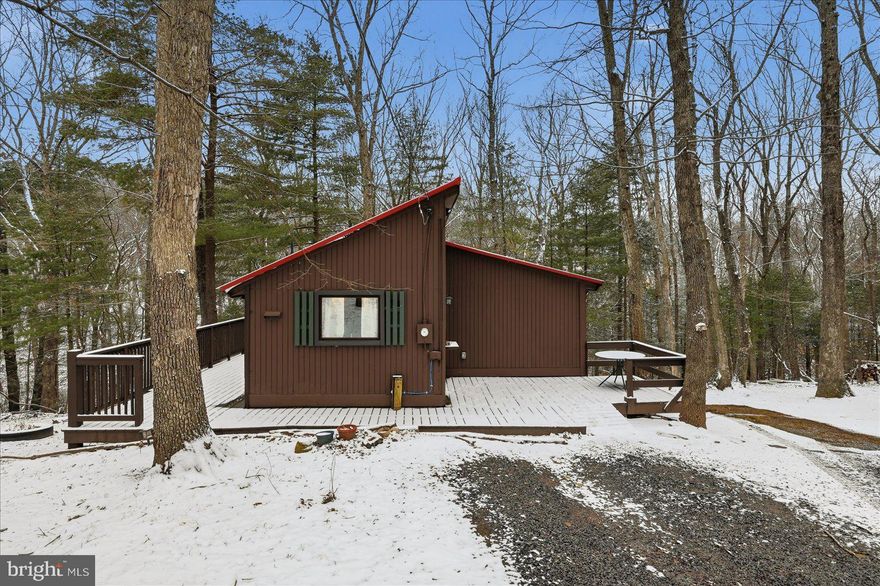 Welcome to this charming mountain cabin retreat on over 2 acres of peaceful, wooded surroundings!
Offering 3 gracious bedrooms and a full bath , this inviting home features updated hardwood flooring, high beamed ceilings, and baseboard heating throughout. An added pellet stove in the living room creates a cozy atmosphere, perfect for enjoying cool mountain evenings. Large windows frame beautiful wooded mountain views, bringing the outdoors in and creating a relaxing atmosphere. Take in the soft spring mountain air from your extended deck. The unfinished basement provides open laundry room, and excellent potential for additional storage, or a workshop. With plenty of room to roam, this property offers privacy, nature, and the ideal setting for a full-time residence, vacation getaway, or investment opportunity! Located the Sleepy Hollow community, and down the road from a community lake, don't miss your chance to own Your Private Mountain escape!