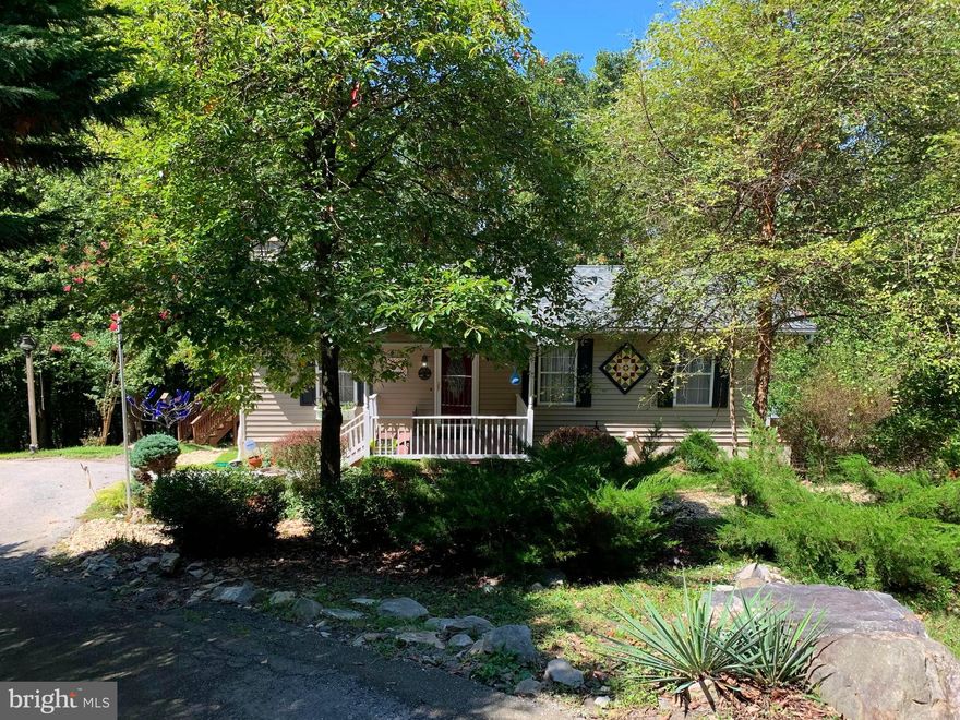 LOCATED ON A QUIET RURAL STREET IN MOUNTAIN SETTING DEVELOPEMENT.  COMMUNITY LAKE CLUB  MEMBERSHIP AVAILABLE , OFFERING PRIVATE BEACH & SWIMMING / BOATING / FISHING AND CLUBHOSE WTH RESTAURANT. THIS QUAINT HOME IS PERFECT FOR USE AS EITHER AN AIR B&B OR AS YOUR OWN PRIVATE GET-A-WAY. THE FIRST FLOOR FEATURES INCLUDE; A GREAT ROOM (COMBINATION LIVING ROOM, DINING ROOM & KITCHEN) WITH GAS LOG FIREPLACE AND HARDWOOD FLOORING / TWO BEDROOMS AND A REMODLED BATH.  ONE OF THE BEDROOMS AND THE GREATROOM HAVE ACCESS TO THE UPPER LEVEL COVERED PORCH WHICH OVERLOOKS THE LARGE BACK YARD WITH HORSESHOE PITS AND SEASONAL VIEWS OF THE VALLEY BELOW. ALL OF THIS BACKING TO  BACKING TO TREES FOR PRIVACY. THE FINISHED WALK OUT BASEMENT HAS ANOTHER LARGE BEDROOM / SECOND FULL BATH / FAMILY ROOM AND DEN (WHICH IS SET UP AS A FOURTH BEDROOM, NO CLOSET) AND A 12'X15' WORKSOP AREA. THE BEDROOM AND FAMILY ROOM OPEN TO THE LOWER LEVEL SCREENED PORCH. NEW ARCHITECTURAL SHINGLE ROOF AND COMPLETE HVAC, BOTH REPLACED 2 YEARS AGO!!! CIRULAR DRIVEWAY FOR EASY ACCESS AND A  SHED FOR MOWER / AND EXTRA STORAGE.