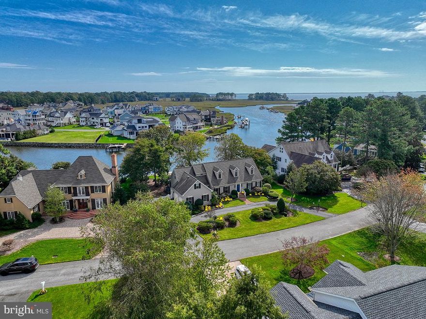 Introducing an Extraordinary Waterfront Haven in the Heart of Rehoboth Beach Yacht and Country Club. Rarely does a property of such exceptional caliber become available. This remarkable waterfront home offers a lifestyle that dreams are made of. With breathtaking panoramic views down Bald Eagle Creek to Rehoboth Bay, this home's location is truly unparalleled. Upon arrival, you'll be greeted by an inviting foyer that sets the tone for what lies beyond. This home is bathed in natural light, creating an ambiance of warmth and serenity. The heart of the home is undoubtedly the great room, featuring a magnificent stone fireplace that beckons gatherings and cozy evenings by the fire. But it's the sunroom that steals the show, a sanctuary of tranquility where you can immerse yourself in your favorite book while being enveloped by the shimmering waterscape that surrounds you, every day in every season. Step outside onto the sun deck, a haven of outdoor bliss adorned with soothing fountains and a serene pond. Here, you'll find the perfect spot to unwind, entertain, and savor the beauty of your waterfront oasis. The main level boasts a waterfront primary suite that is nothing short of a personal sanctuary, complete with easy access to your backyard paradise. Additionally, two more rooms on this level provide versatility, offering the ideal spaces for a home office and a welcoming guest room. Ascend the stairs to discover a huge bonus room or second primary suite and two more generously sized bedrooms, each with its own unique charm and views that will inspire you daily. For those seeking a premier country club lifestyle, the option of a private membership awaits (contact us for further details on RBCC membership). Just down the street lies the Rehoboth Beach Country Club clubhouse, where you can indulge in superb dining options, a bayfront pool, a state-of-the-art fitness center, tennis, pickleball and an impressive 18-hole Championship golf course. This waterfront gem is more than a home; it's a lifestyle opportunity that simply cannot be replicated. Don't miss your chance to make this incredibly special waterfront retreat your own. Views like this are a rarity, and the chance to walk right outside your back door to your boat is an invitation to create memories that will last a lifetime. Seize this extraordinary opportunity and experience the epitome of coastal living.