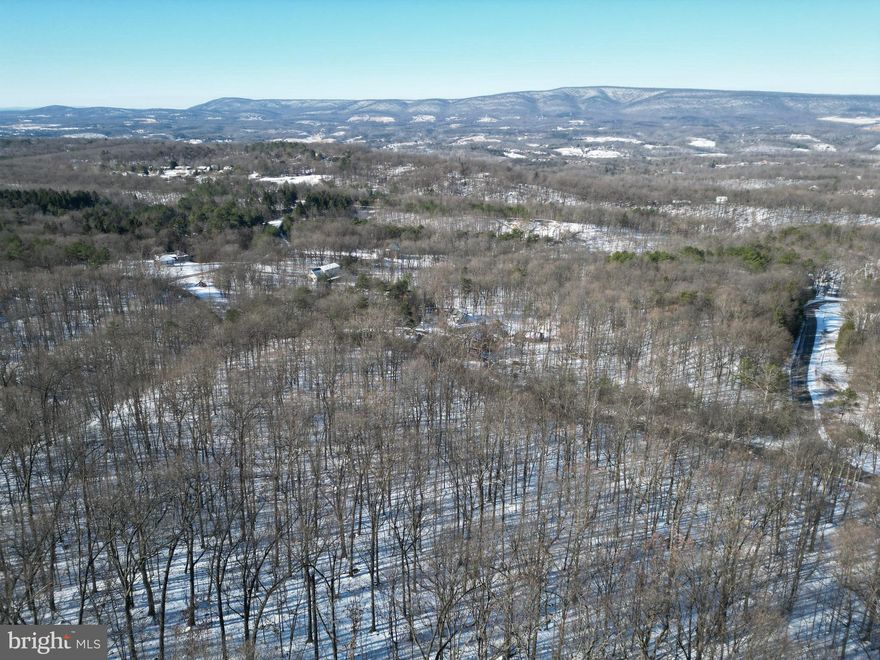 ***Large Parcel with Mountain Views***

Take a look at this large parcel situated in the esteemed Round Top Estates. This property captures the westerly views of the mountains across the valley that are miles away. A vast majority of the land is gently sloping with fantastic build locations. Large oaks and hickories standing on the property would make great features to a home tucked into the mountain side.  On the upper portion of the parcel large rocks are scattered which could be used to line a driveway, use for landscaping or even give the perfect touch to the entrance of a home. Being the parcel is over 20 acres, hunting is allowed.  Wildlife is abundant on the property just judging by the tracks in the snow and deer sign. 

There are 2 separate drain field locations on the property giving the future owners options for home placement. Electric poles are currently at the top and bottom of the property making for a simpler connection. All roads leading to the property are paved meaning no dust or mud on your car while traveling to and from your home within the subdivision.