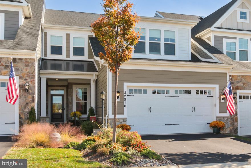 BETTER than new AND MOVE-IN READY!!  WELCOME to this stunning home in sought-after Birchwood at Brambleton!!  Absolutely STUNNING Winchester FAIRWINDS model, featuring almost 4,100 finished square feet on 3 levels!!  This beautiful home features 4 BR's / 3 full Baths and is absolutely LOADED with upgrades!!  Prepare to fall in love with the mint condition LVP plank flooring throughout most of the main & upper levels, as well as the GOURMET kitchen with high-end finishes & cabinets, quartz-granite counters, stainless appliances and lighting!!  The main level living room features upscale gas fireplace, built-ins and easy access to both the deck & fenced / landscaped backyard, as well as the primary suite and adjacent ensuite high-end bathroom!!  The second bedroom / bathroom and laundry room are also located on the main level, and when you access the garage you'll notice the charging station for an EV!!  Upper level of this beauty features a large family room complete with wet bar, as well as walk out to a gorgeous upper level 2nd deck!!  Don't forget two additional bedrooms here, the 3rd full bath, as well as a beautiful CUSTOM dressing room!!  Lower basement level is fully finished, featuring over 1,300 finished square feet, a large rec room, separate den + huge storage room with rough-in for a 4th full bath!!  The upgrades in this amazing home are incredibly numerous - don't miss accessing all of the details in BRIGHT documents!!  WELCOME HOME to sought-after Birchwood at Brambleton - a 55+ neighborhood with TONS of amenities & fabulous access to everything!!