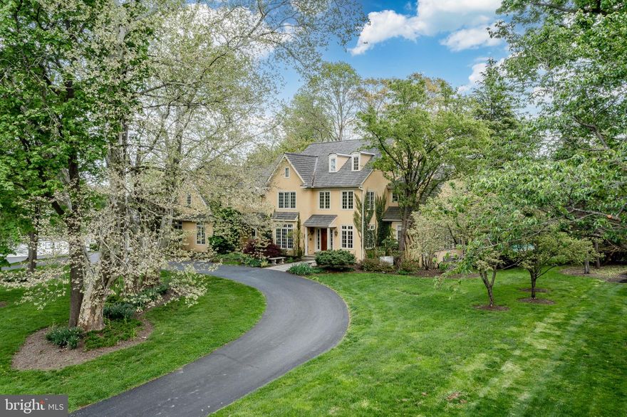 There are homes that check boxes and then there are homes that create a feeling. This is the latter.

Set quietly atop 1.3 exquisitely landscaped acres in the coveted Harrison Estate enclave, this European inspired residence is a study in restraint, proportion, and presence, where every detail has been considered and nothing is accidental. The approach is discreet yet impressive, opening to a circular drive and a home that reveals itself slowly, the way all truly special properties do.

Inside, nearly 7,000 square feet of interiors unfold with quiet drama. Sunlight pours through expansive windows, casting a warm southern glow across rich wood, marble, and tailored finishes. A breathtaking two story foyer introduces a sculptural, hand forged iron staircase by M. Cohen & Sons, less a feature, more a piece of art, setting an immediate tone of craftsmanship and permanence.

The living spaces are both elevated and livable. A vaulted family room, anchored by a custom stone fireplace and artisan built millwork by Don Green, invites gathering without formality. The dining room, warmed by a Chesney fireplace, was designed for lingering evenings and effortless entertaining. And at the heart of it all, a true chef’s kitchen, equipped with Viking and Sub Zero appliances, functions as both a workspace and a social hub, seamlessly connecting to a sunlit breakfast room and beyond.

Then, the moment everything opens up.

French doors lead to a sweeping flagstone terrace, perfectly oriented to the south, where the landscape becomes part of the living experience. The gardens, lush, natural, and thoughtfully curated to be pesticide free, create a setting that feels both grounded and transportive. The pool, with its twin Badu swim jets, offers the rare luxury of both relaxation and performance, all set against uninterrupted hilltop views that shift beautifully with the seasons.

Upstairs, the primary suite is not just private, it is restorative. A sitting room, its own balcony, dual walk in closets, and a Carrara marble bath come together to create a retreat that feels closer to a boutique hotel than a residence. Additional bedrooms are generously proportioned and quietly refined, while a finished walk up attic offers flexibility for guests, studio space, or retreat.

The lower level continues the narrative of thoughtful living, a fully realized extension of the home with a media lounge, game room, kitchenette, fitness space, and full bath, designed not as an afterthought, but as an integral part of the lifestyle.

Behind the scenes, every modern convenience is in place, multi zone climate control, whole home connectivity, security, generator, ensuring comfort and confidence without ever intruding on the aesthetic.

And yet, for all its privacy and serenity, the home remains remarkably connected, just minutes to the Main Line’s most prestigious schools, dining destinations, shopping, Center City Philadelphia, and Philadelphia International Airport.

This is a home for someone who understands that true luxury is not loud. It is felt. It is lived. And once experienced, it is not easily forgotten.

Photos and Media Coming Soon!