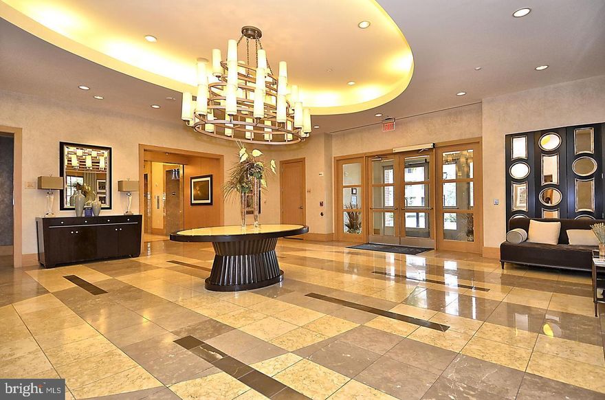 Experience the epitome of refined urban living at this stylish one-bedroom condominium unit located directly across the renowned Pike & Rose lifestyle district. This fabulous unit features a smart, open configuration suitable for even the most discerning of buyers. Enter directly into a sprawling open space, defined by the wrap-around kitchen on the left, complete with granite countertops, milled cabinetry, and all the modern appliances one would need. The vast living room, noted for its open space and premium hardwood floors, opens up into a glass-enclosed sunroom, where floor-to-ceiling window walls bathe the entire space with natural light and offer spectacular 180-degree views of the city skyline and landscape beyond. The spacious bedroom provides enough space for a working area, and features high ceilings, a large window, and a generous walk-in closet for your comfort. A large bathroom includes access from both the bedroom and the living room, and is complete with upgraded fixtures and gleaming tiles. In addition, the unit also includes a spare closet, a water tank closet, and a laundry closet for your convenience. 
This one-of-a-kind one bedroom unit is located at The Sterling, an upscale condominium building located just one block from Pike & Rose - borrowing from its revitalizing energy, yet distant enough to maintain a sense of quiet serenity. The building boasts stylish amenities such as a marble-paved lobby with 24-hour concierge, a vast club room outfitted with sleek furniture, a well-appointed gym with state-of-the-art equipment, a sparkling outdoor pool, and beautifully manicured gardens featuring a sizable patio and grilling area. The unit also comes with its own underground parking space, and is also strategically located near multiple modes of transportation, including several bus stops and the North Bethesda Metro Station. Don’t miss this opportunity to live in one of the most lavishly-appointed one bedroom units in North Bethesda