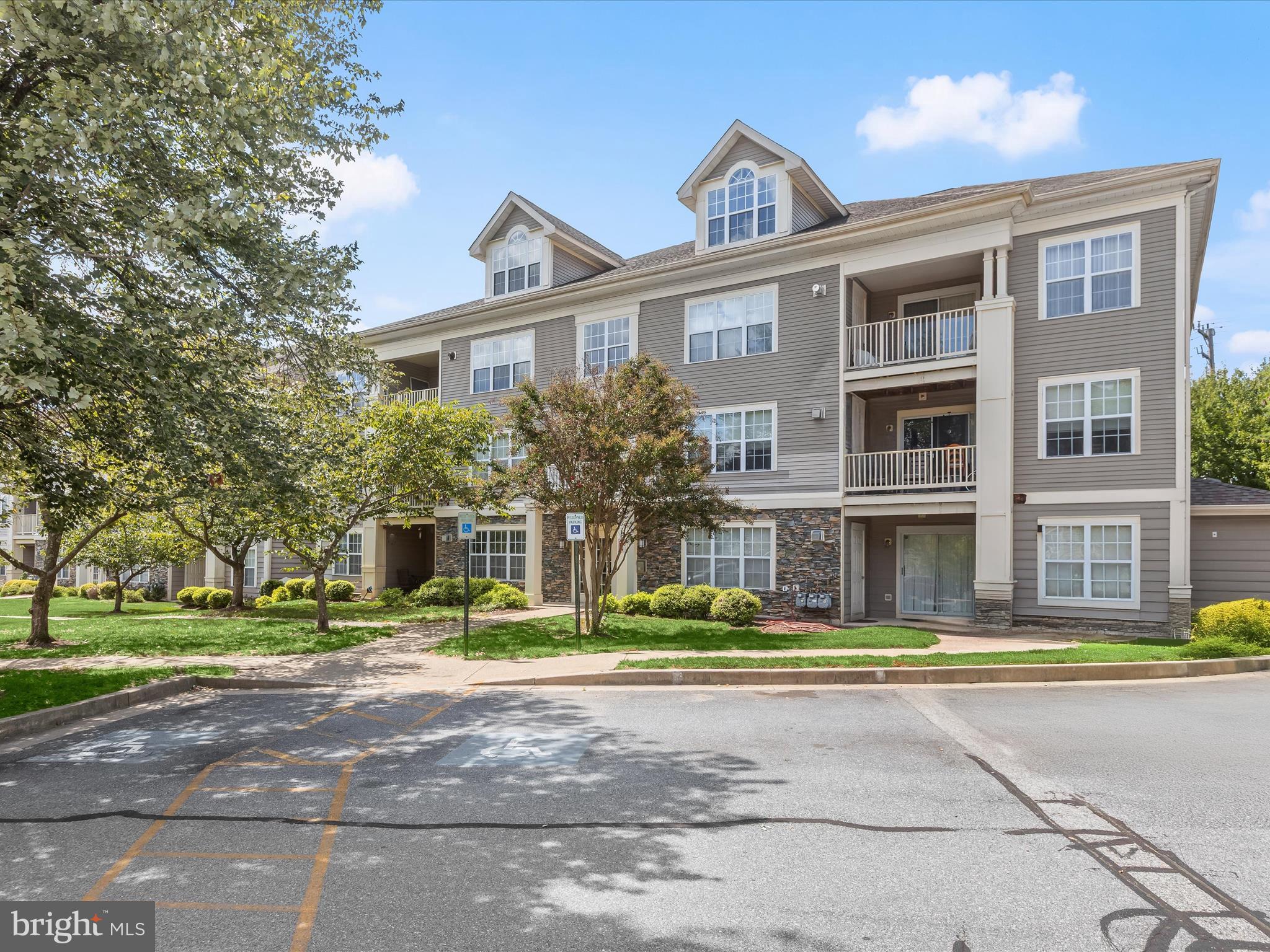 This beauty is back on the market and ready to go!!! Buyer's got cold feet. Someone's loss is someone else's gain. Welcome to the Stone Ridge community of Pikesville! This convenient one-level condominium offers a bright open floor plan with a ceramic tile entry and a neutral color palette throughout. The spacious living room features modern luxury vinyl flooring, a cozy gas-burning fireplace with dentil crown accents on the mantel, and access to a private balcony overlooking tranquil natural views. The dining room, situated just off the kitchen, provides a seamless flow for everyday meals and entertaining. The updated kitchen boasts stainless steel appliances, shaker-style cabinetry with soft-close drawers, and granite counters for both style and functionality. The primary bedroom retreat offers the same luxury flooring found in the main living areas, a generous walk-in closet, and a refreshed en-suite bath with updated hardware, fixtures, and vanity. An additional bedroom with its own walk-in closet and private access to the dual-entry full bath completes the sleeping quarters. Additional highlights include a full-size laundry area, ample storage, and designated parking. Conveniently located near major commuter routes, including I-70, I-695, and I-795, this home combines comfort, style, and ease of living in a desirable Pikesville location.